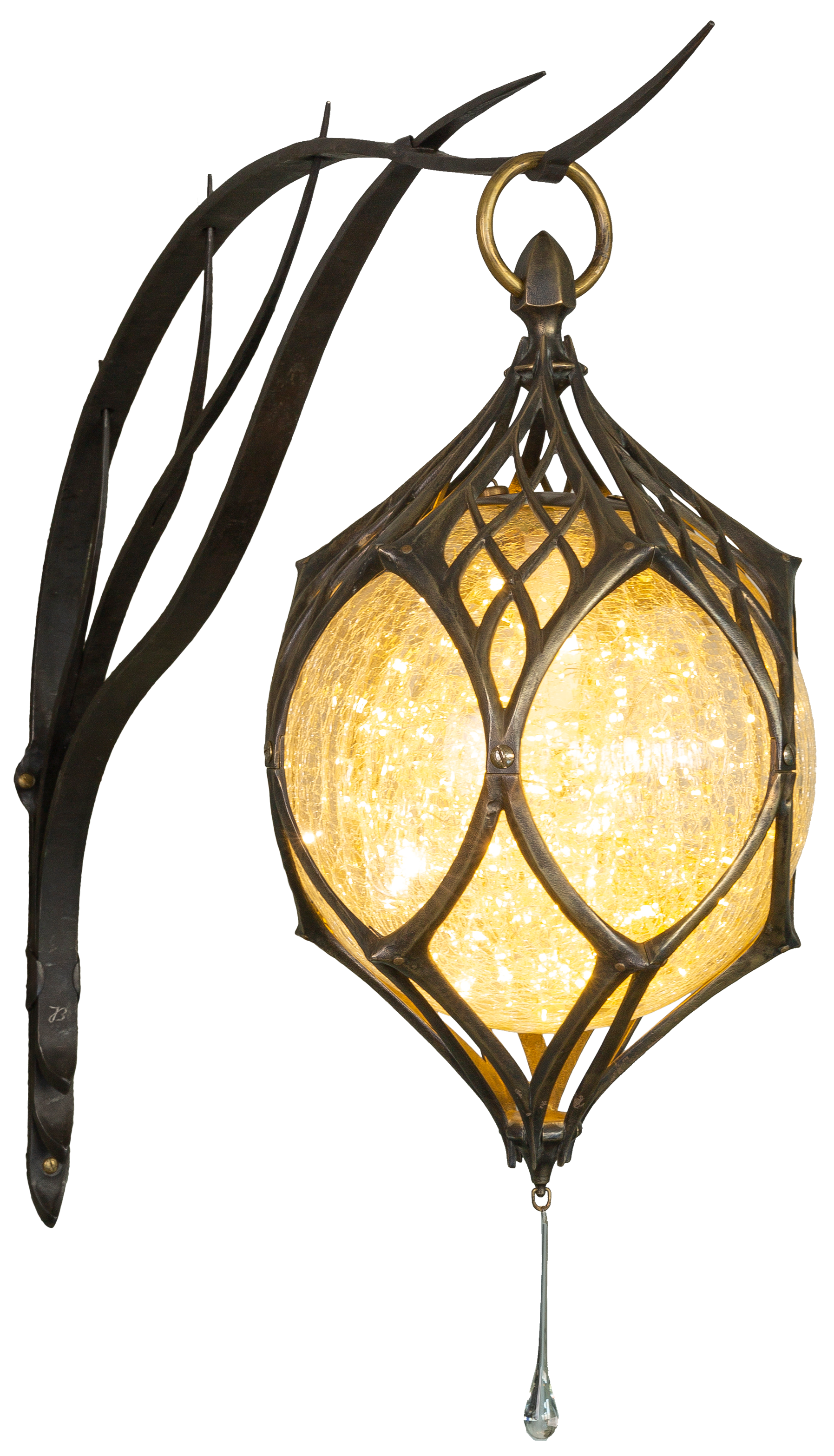 A decorative outdoor wall lantern with a black metal frame and a glowing yellowish-orange glass globe, mounted on a black wall.
