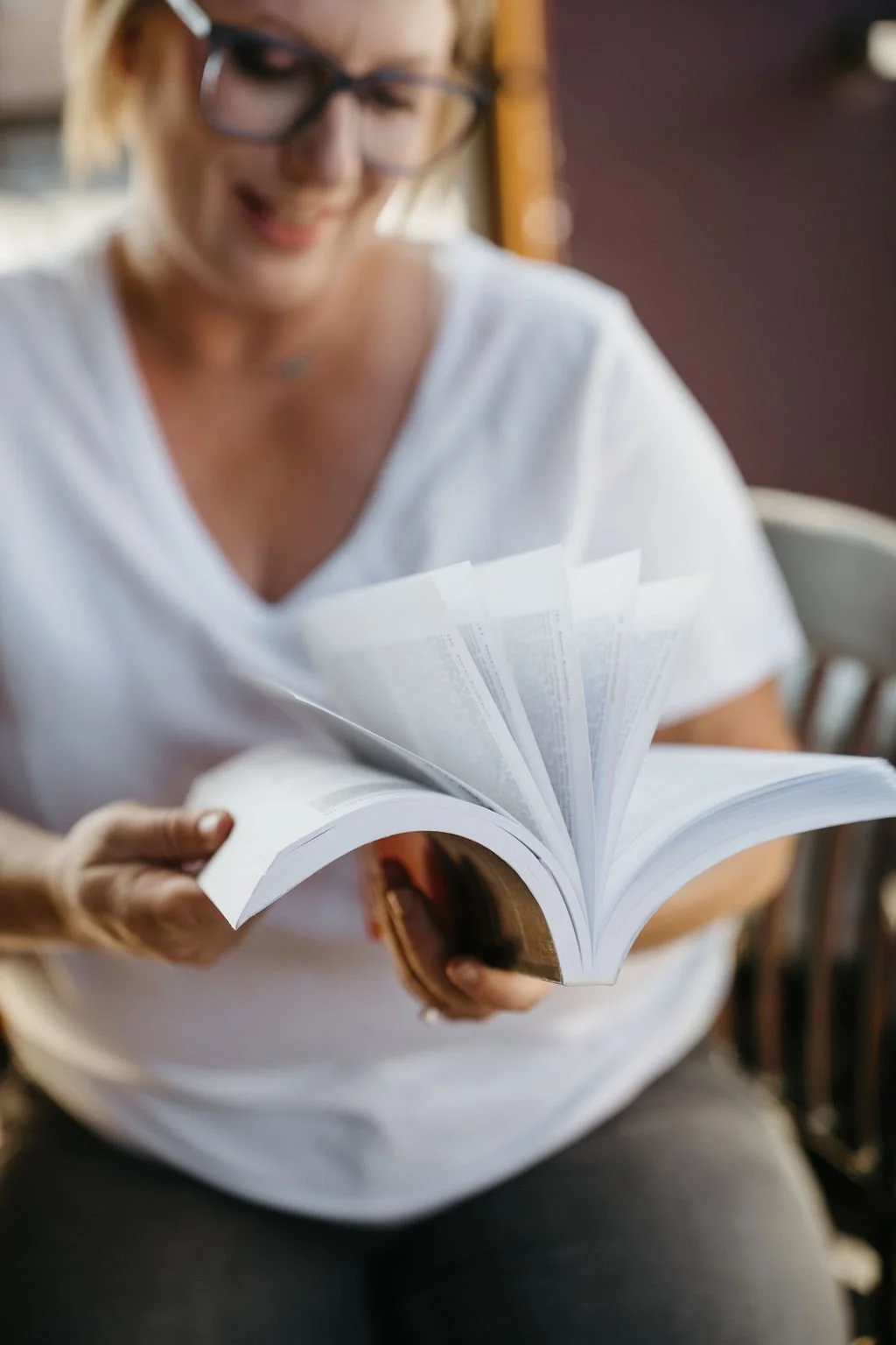 Book Being Flipped Open by a woman with a white tshirt