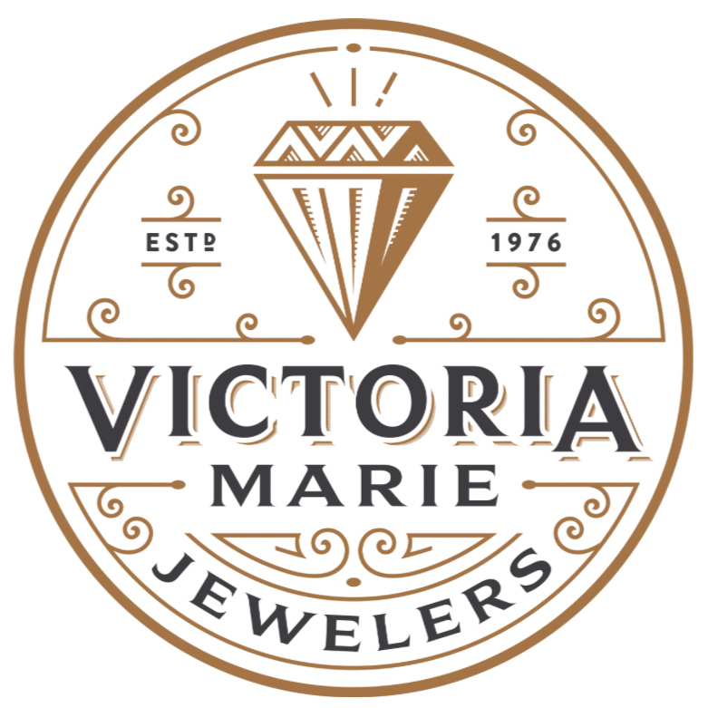 Logo for Victoria Marie Jewelers with a diamond illustration, established in 1976.