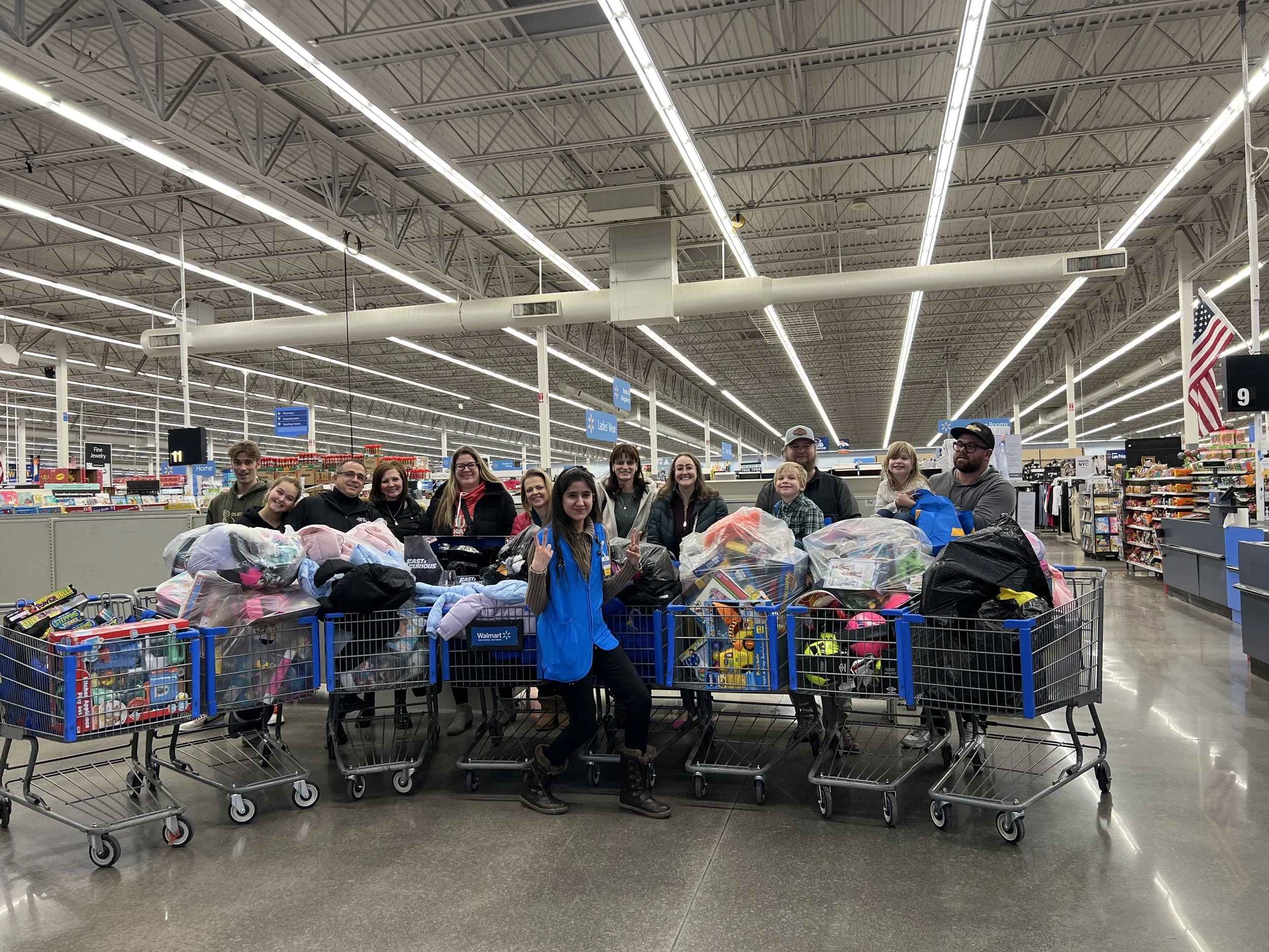 Be the Good Ones volunteers with shopping carts filled with toys at a Walmart store.