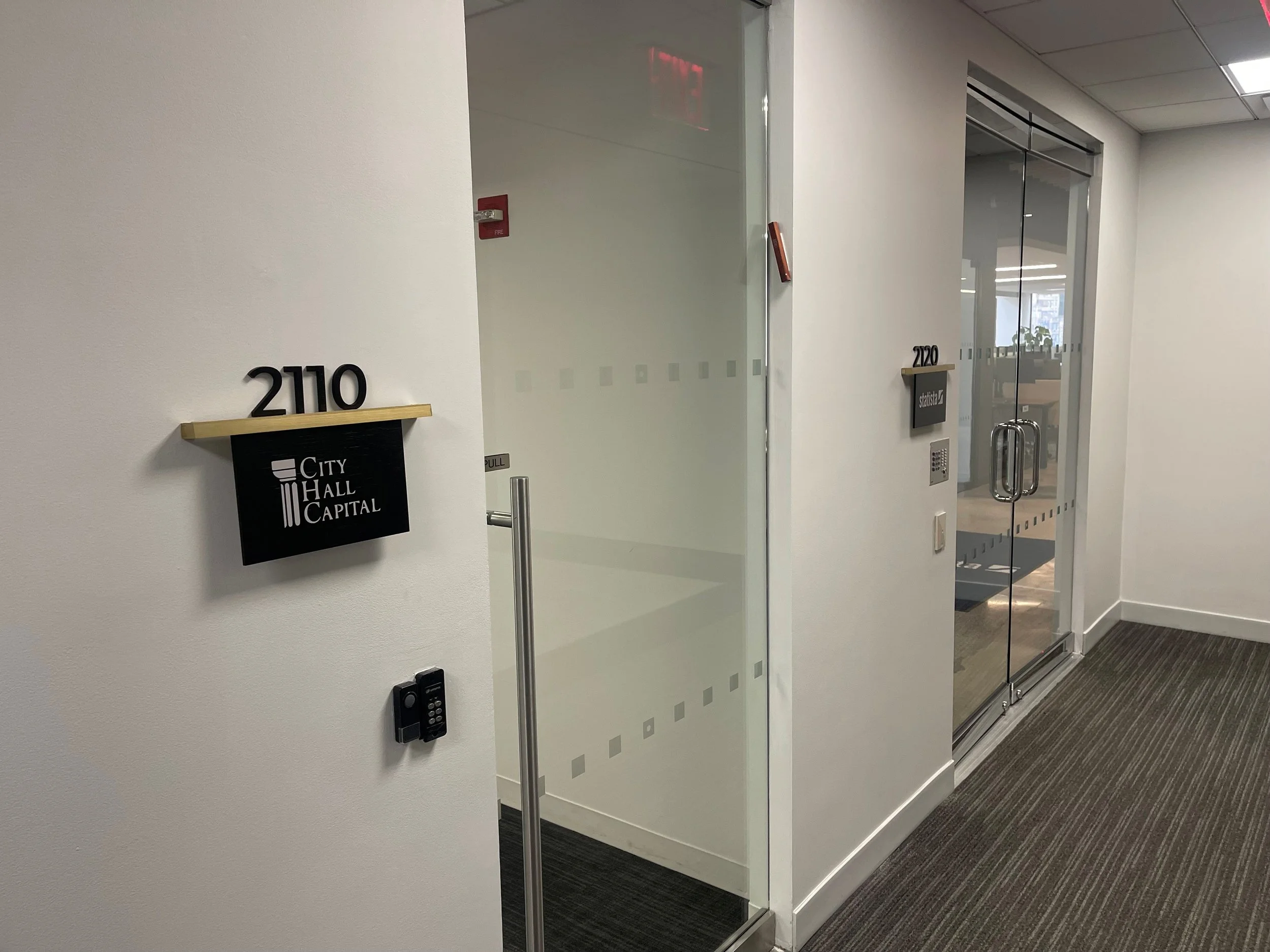 Tenant office signage for CBRE Group with custom bronze detailing