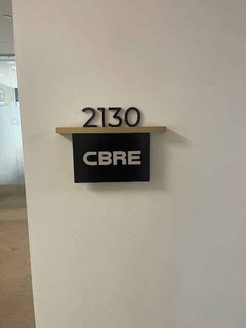 Office signage for CBRE Group with custom bronze detailing