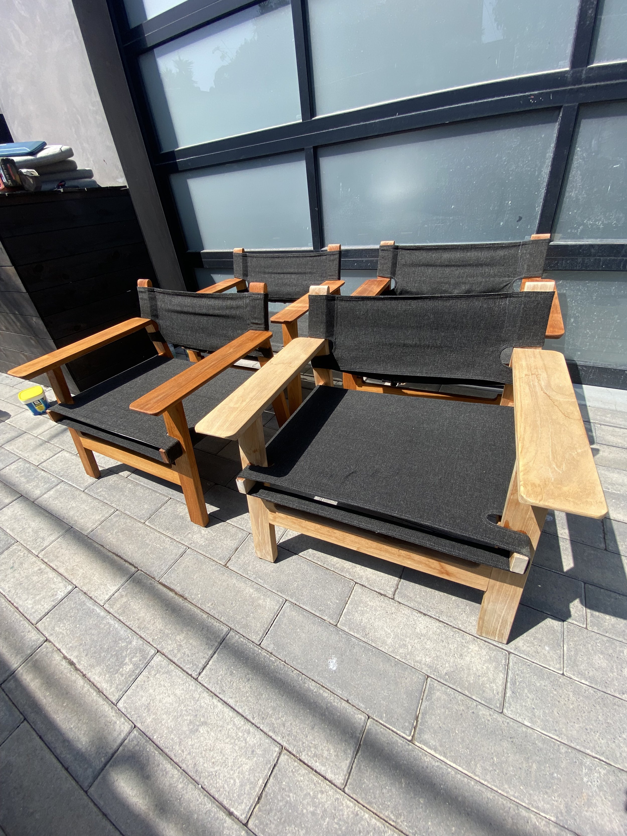 Outdoor chair repair showing fresh wood armrest installation during maintenance visit.