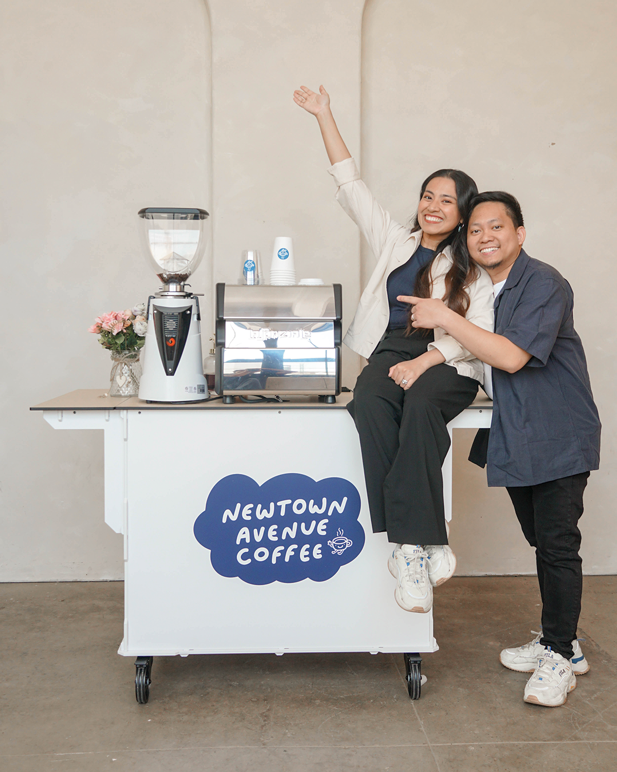 Anna and Aries, owners of Newtown Avenue Coffee with their full coffee bar set up, available for event bookings in Manhattan, Queens, Brooklyn, Long Island, and New Jersey