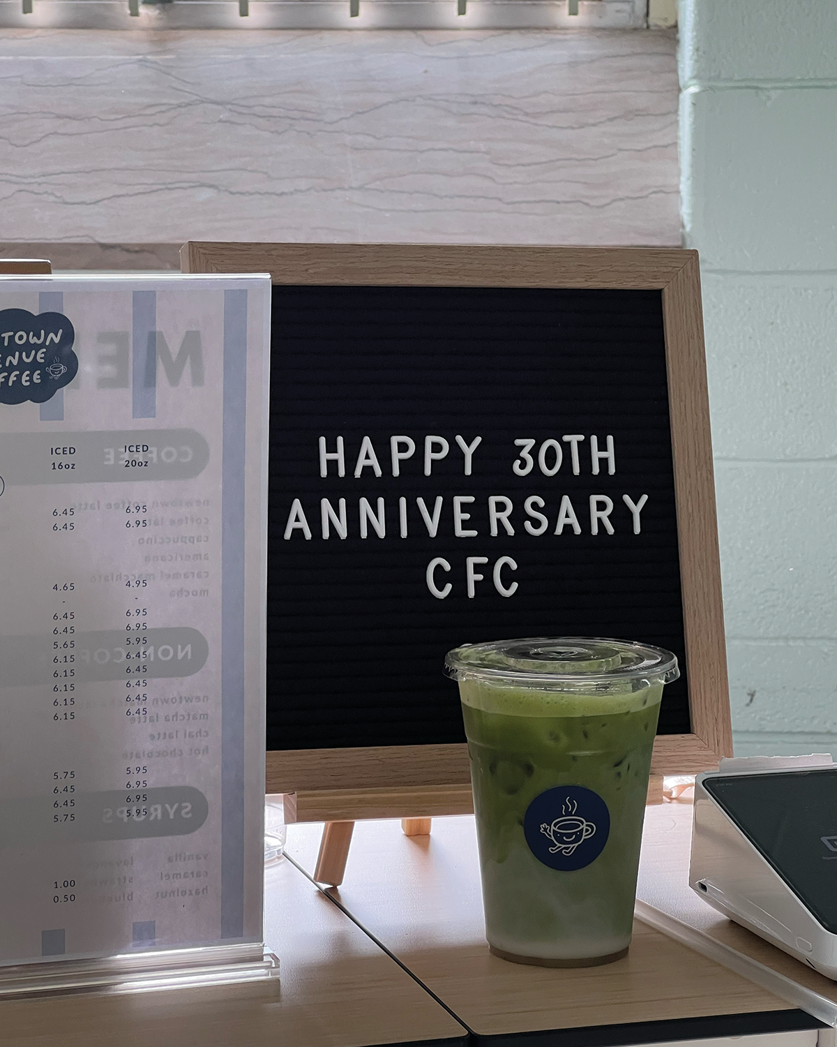 Iced matcha latte with custom signage for a community event in Queens New York
