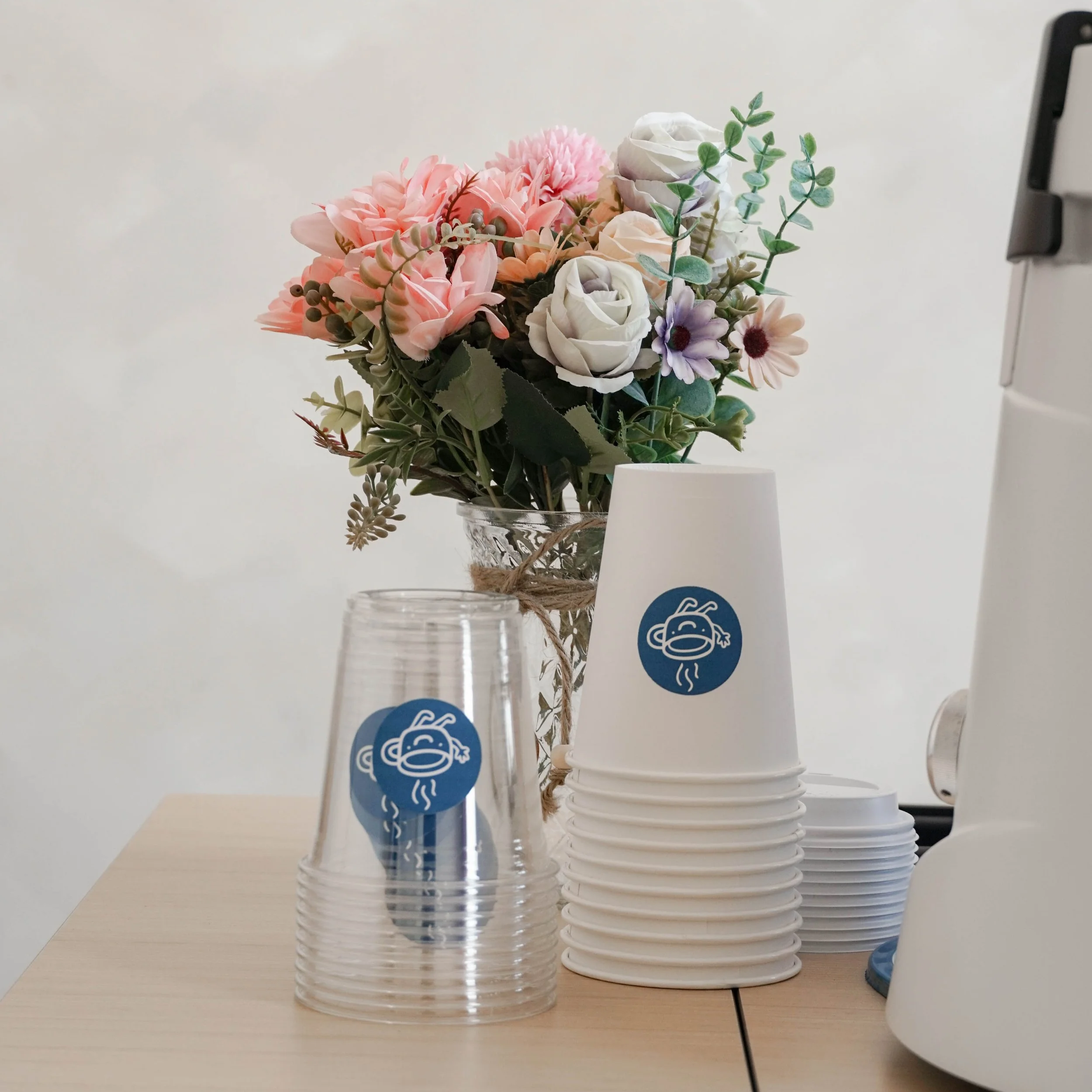 newtown avenue cups with stickers and aesthetic flower decoration for a coffee cart servicing the Greater New York area