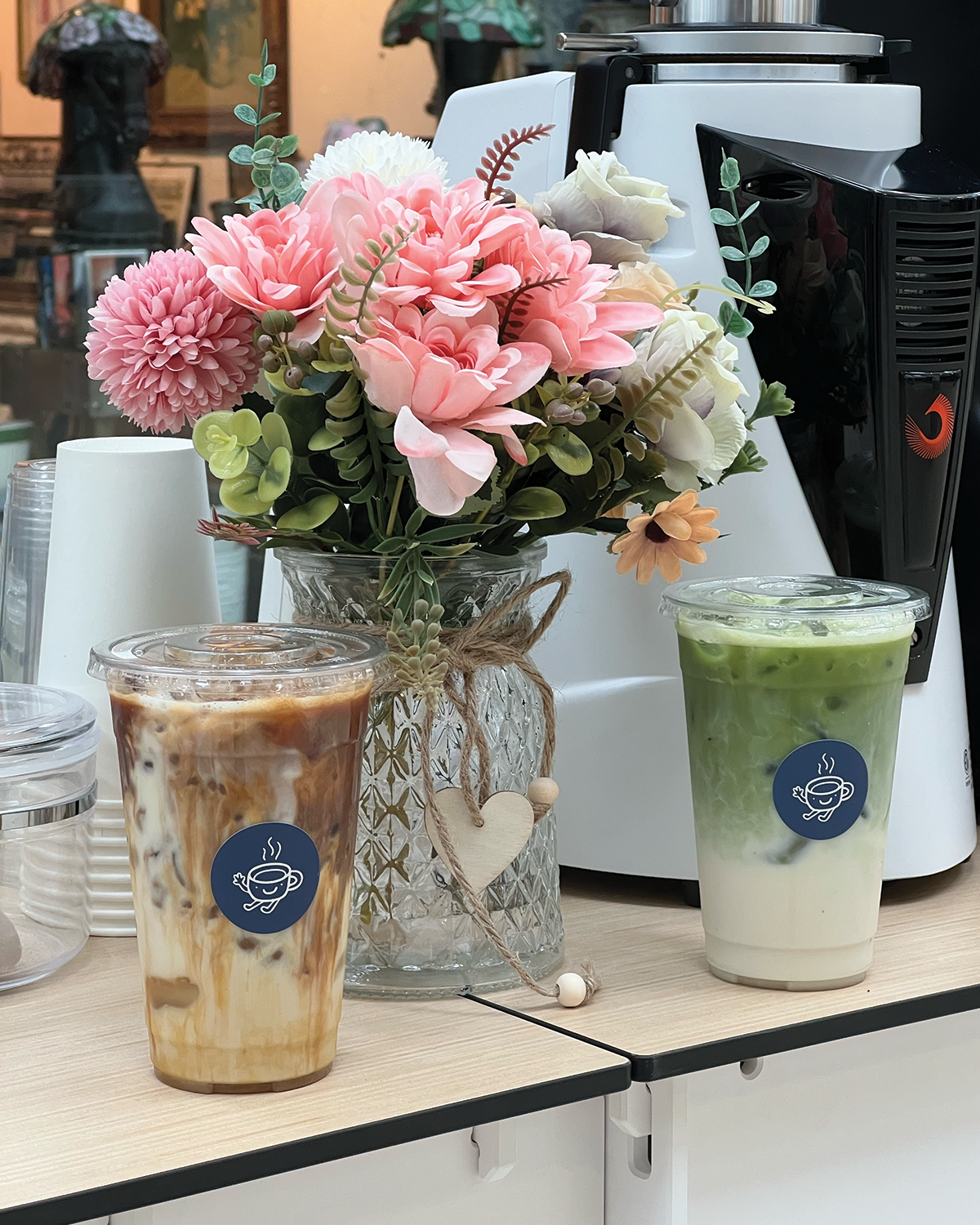 Iced caramel macchiato and matcha latte with cute floral arrangement for coffee bar setup on Long Island