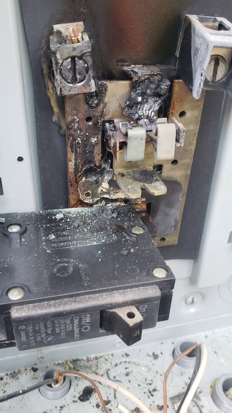 This is what we found when we arrived...a damaged electrical panel with burnt wires and breakers.