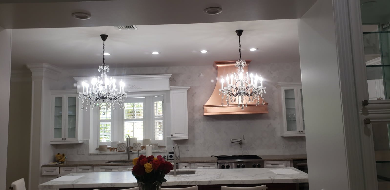 These stunning, luxury chandeliers serve as stunning focal points of a magazine worthy kitchen!