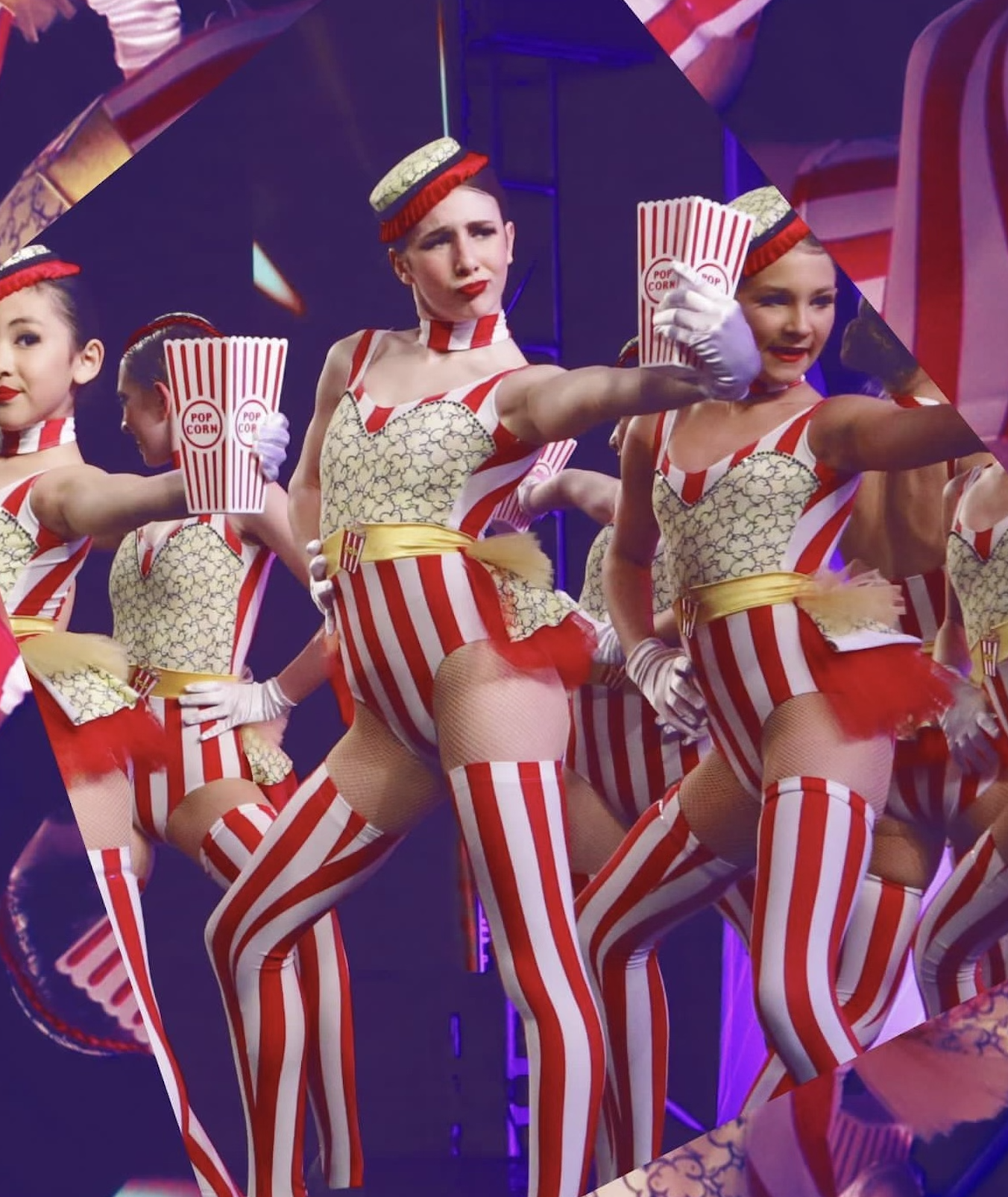 Group of female dancers dressed in red and white striped costumes, resembling popcorn containers, performing on stage.