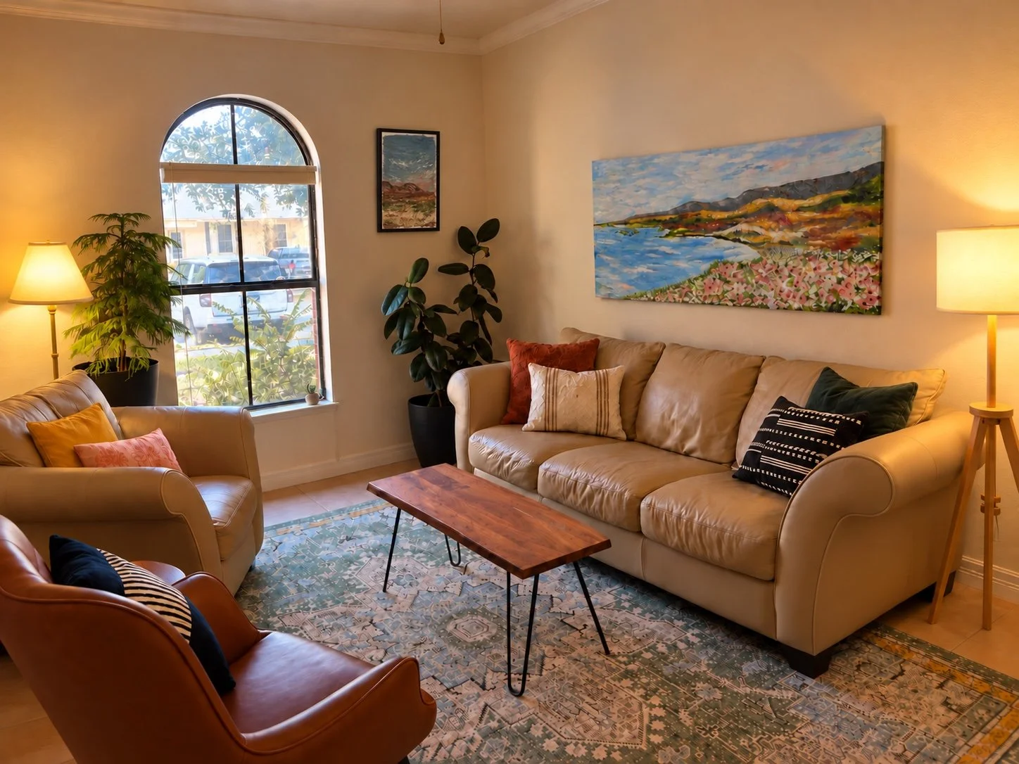 Desert Streams Counseling office in Round Rock, Texas, with a sofa, armchairs, plants, and warm lighting.