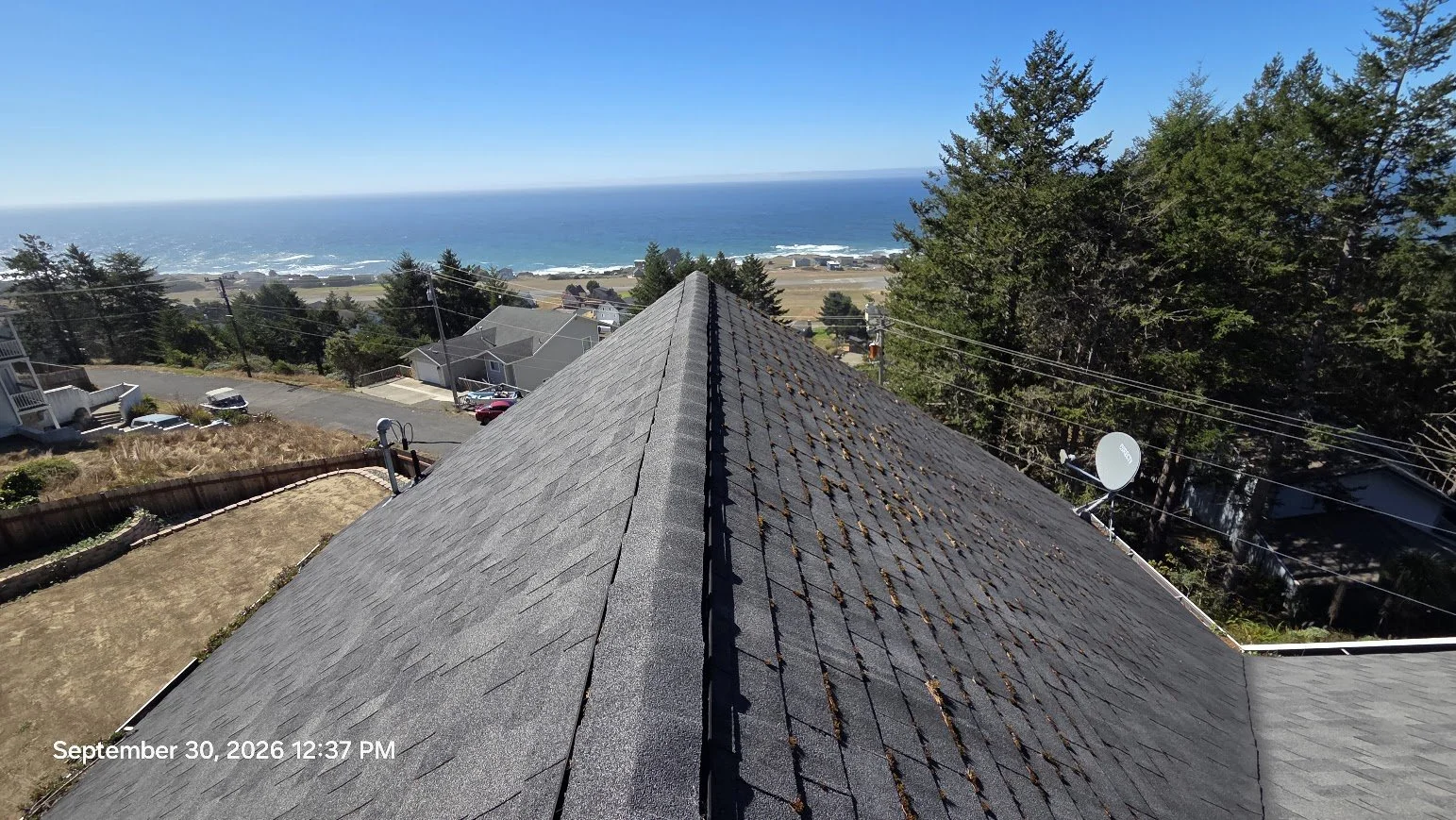 With an 8:12 pitch, this roof was too steep to safely walk normally. Proper harness and fall-protection setup was required to access the roof and complete the work safely.