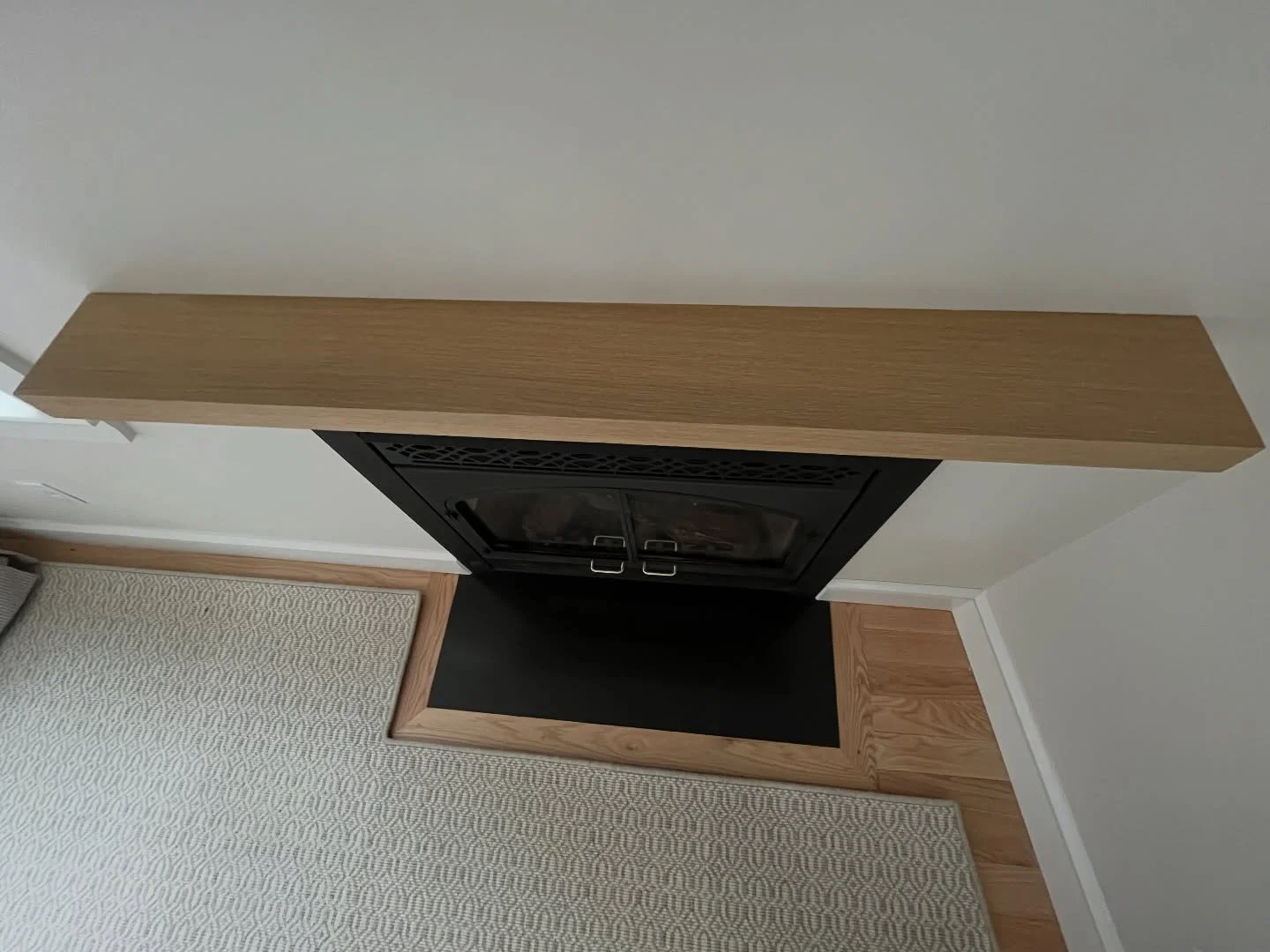 When a carpet is cut and serged with intention it maximizes the comfortable living area of a space. In the small den of our Rockport project the carpet follows a chamfered corner, wraps a fireplace hearth and floats off an angled water-facing wall.

