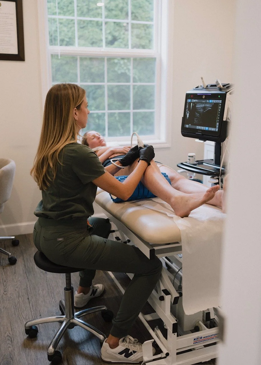 Dr. Rollheiser, ND performing ultrasound-guided pain management injection with the GE Venue Go ultrasound machine.