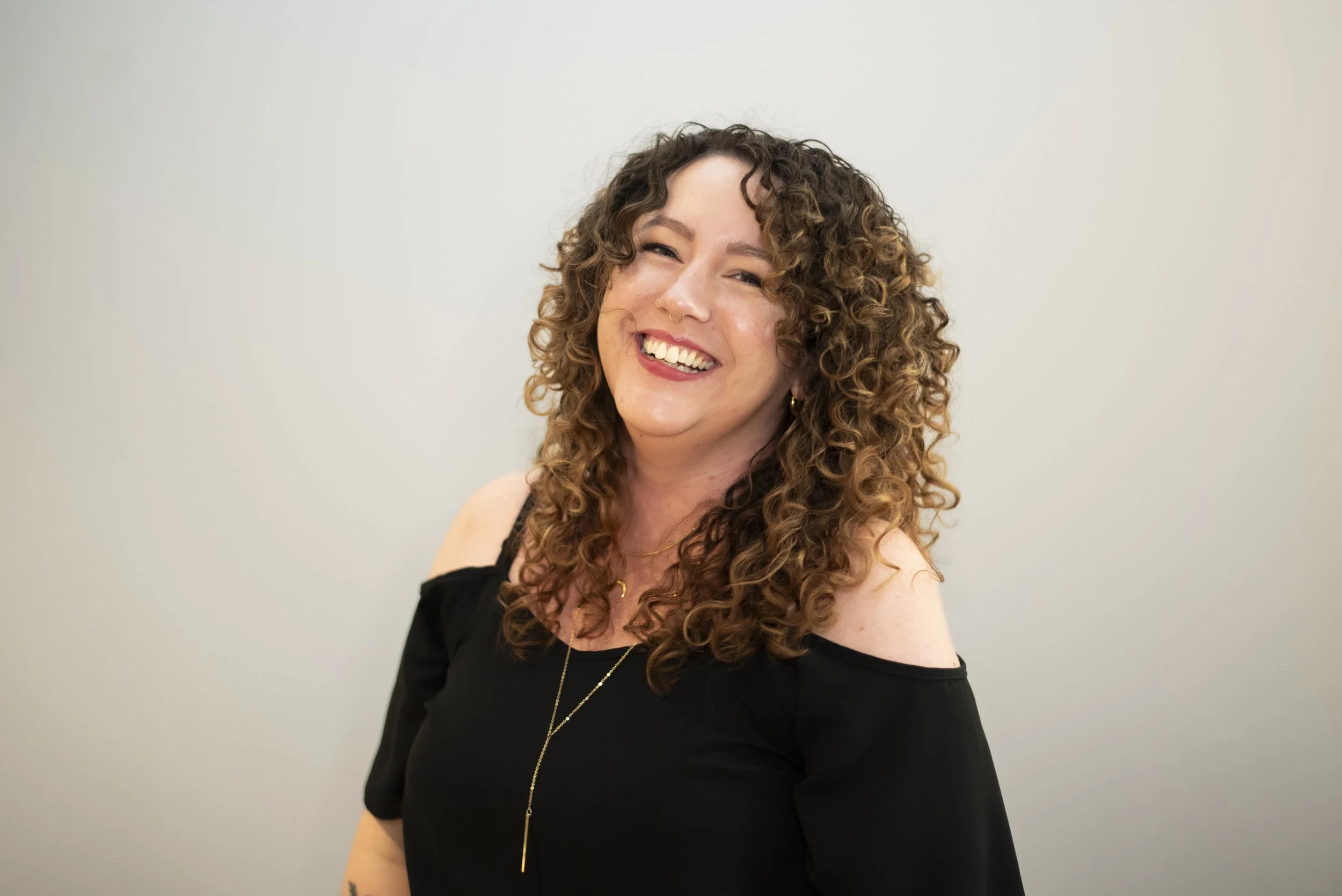 Photo of Cierra, level 3 stylist, smiling at the camera.