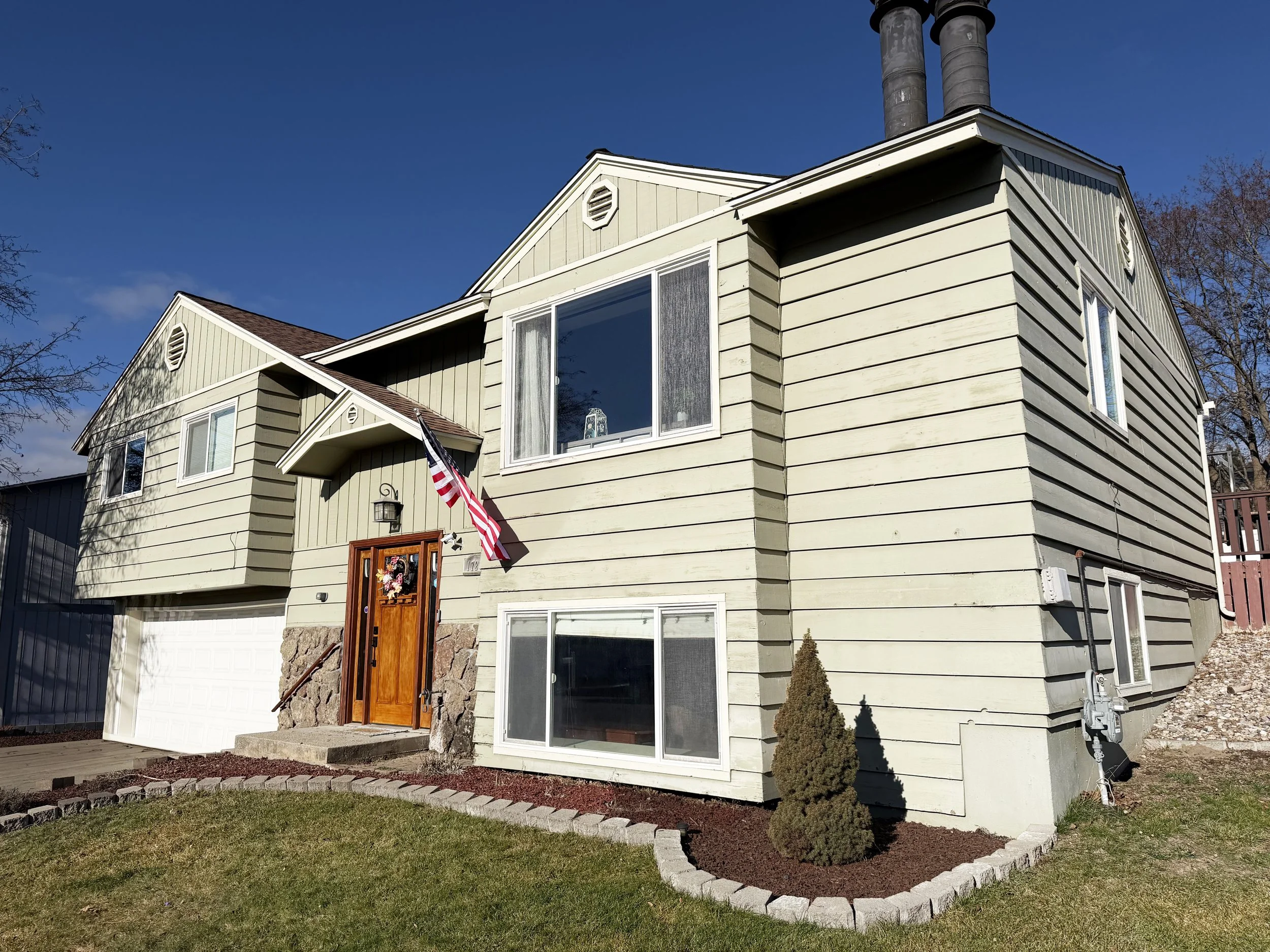 Updated split-level home with attached garage and landscaped yard in Colville WA, sold by top local real estate agent Lucas Hamlin with 5-star client review