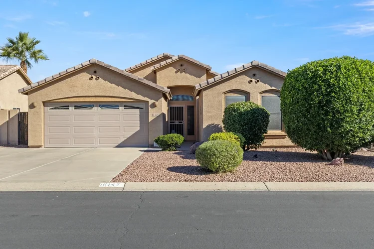 Front yard with desert landscaping and a paver driveway