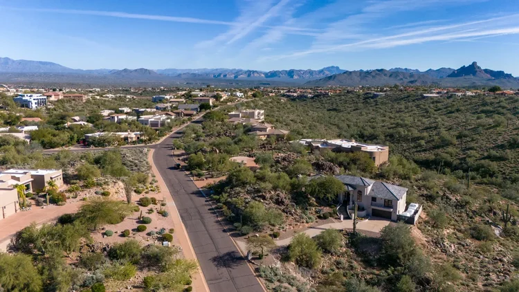 Drone photo of a Fountain Hills home with the Superstition Mountains behind it
