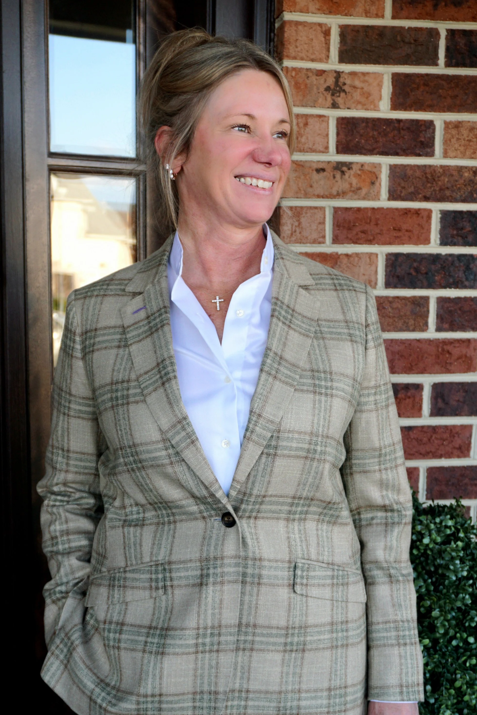 A woman in a custom Dormeuil green plaid sport coat in Virginia Beach, Virginia.