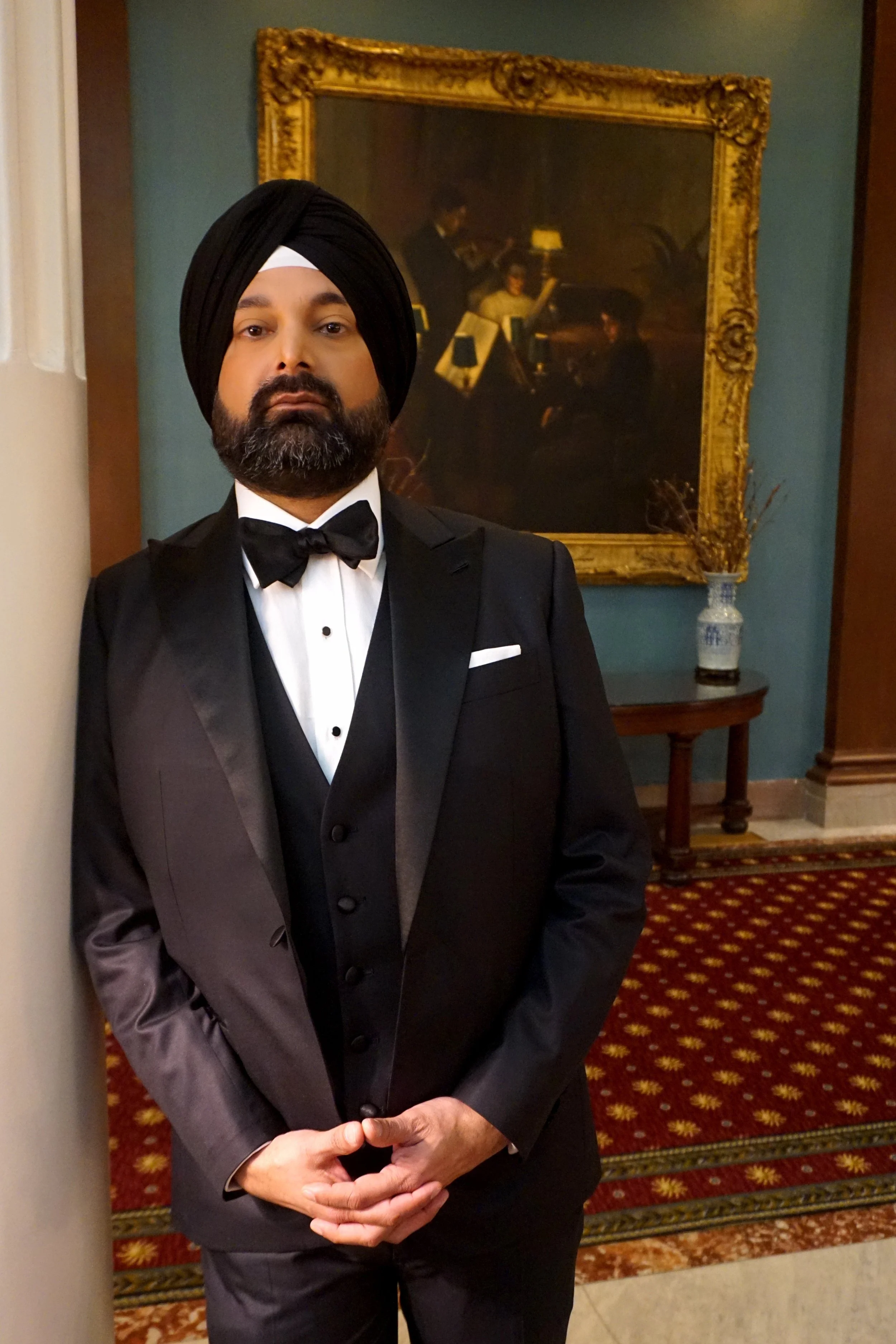 A man in a custom black Dormeuil tuxedo in Richmond, Virginia.