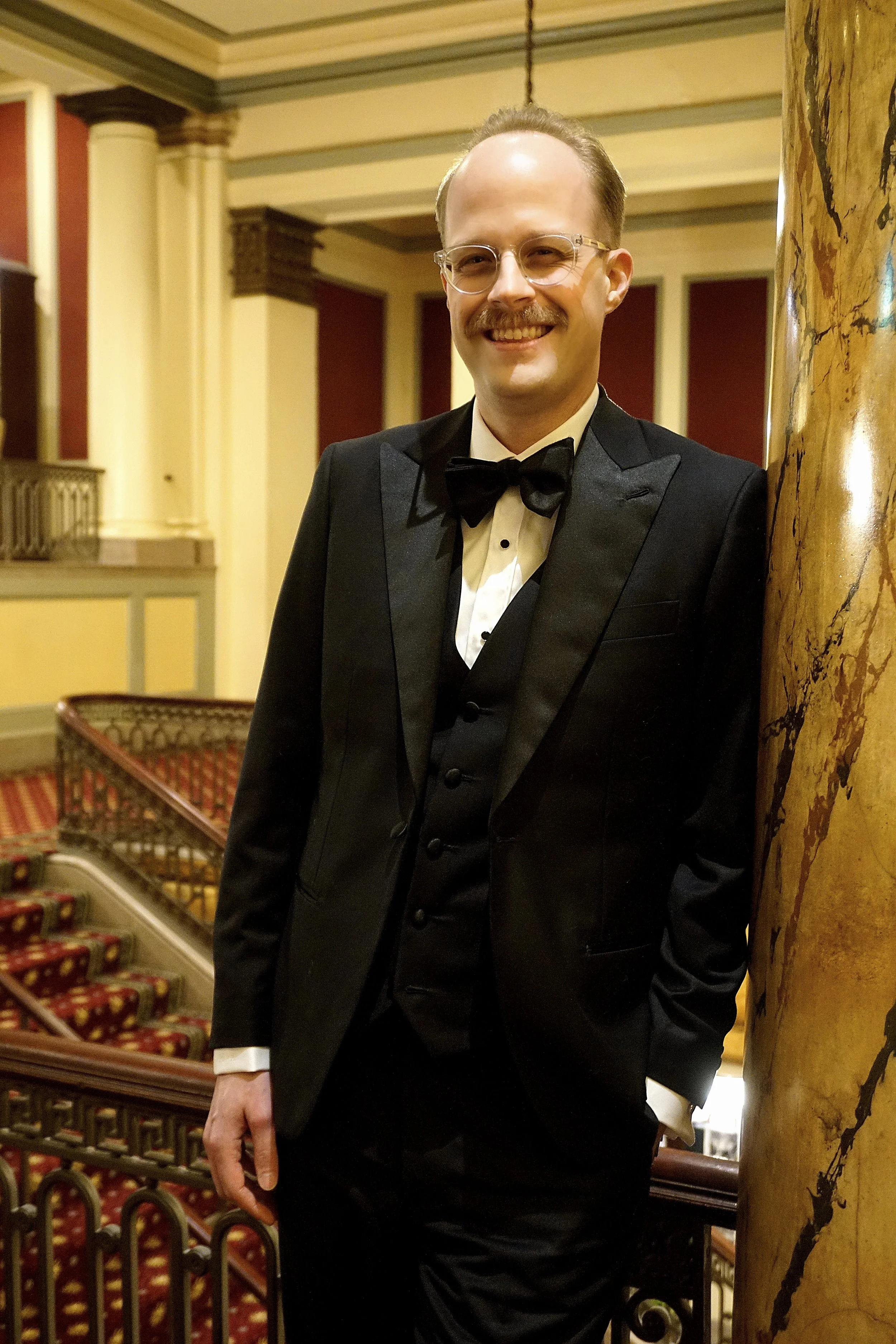 A man in a custom Dormeuil black tuxedo in Richmond, Virginia.