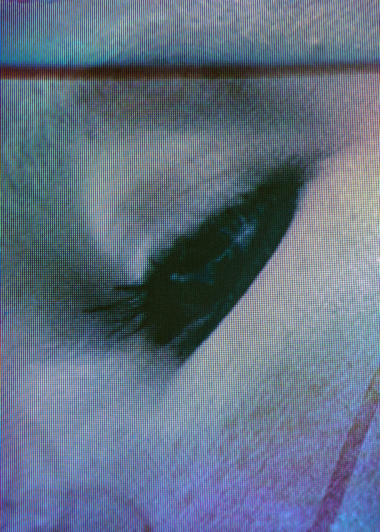 Close-up of a digitized human eye on a screen with pixelated detail.