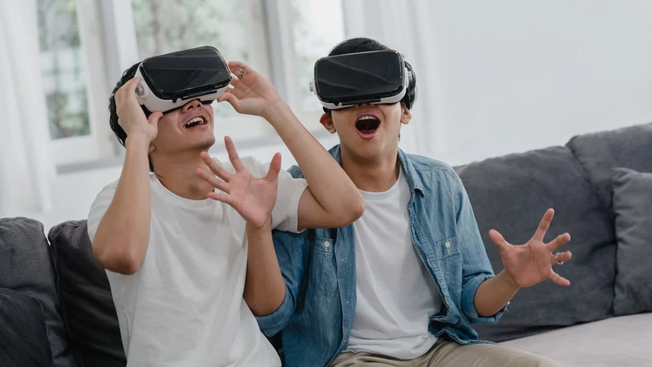 Two teenagers having fun with VR games as part of fun teen birthday party ideas at home.