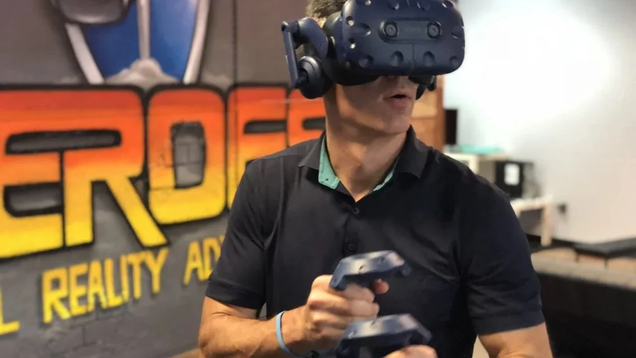 Man using VR headset and controllers indoors