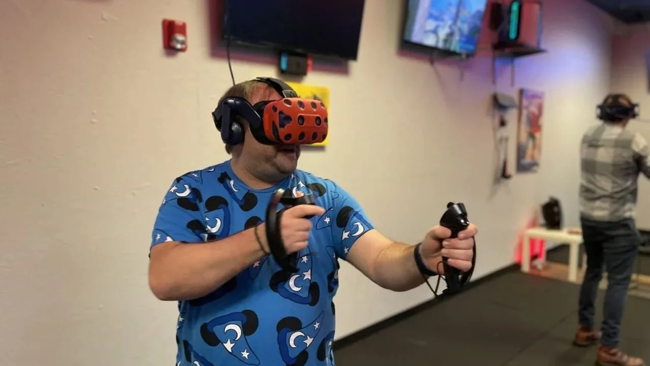 Man playing VR game with headset and controllers