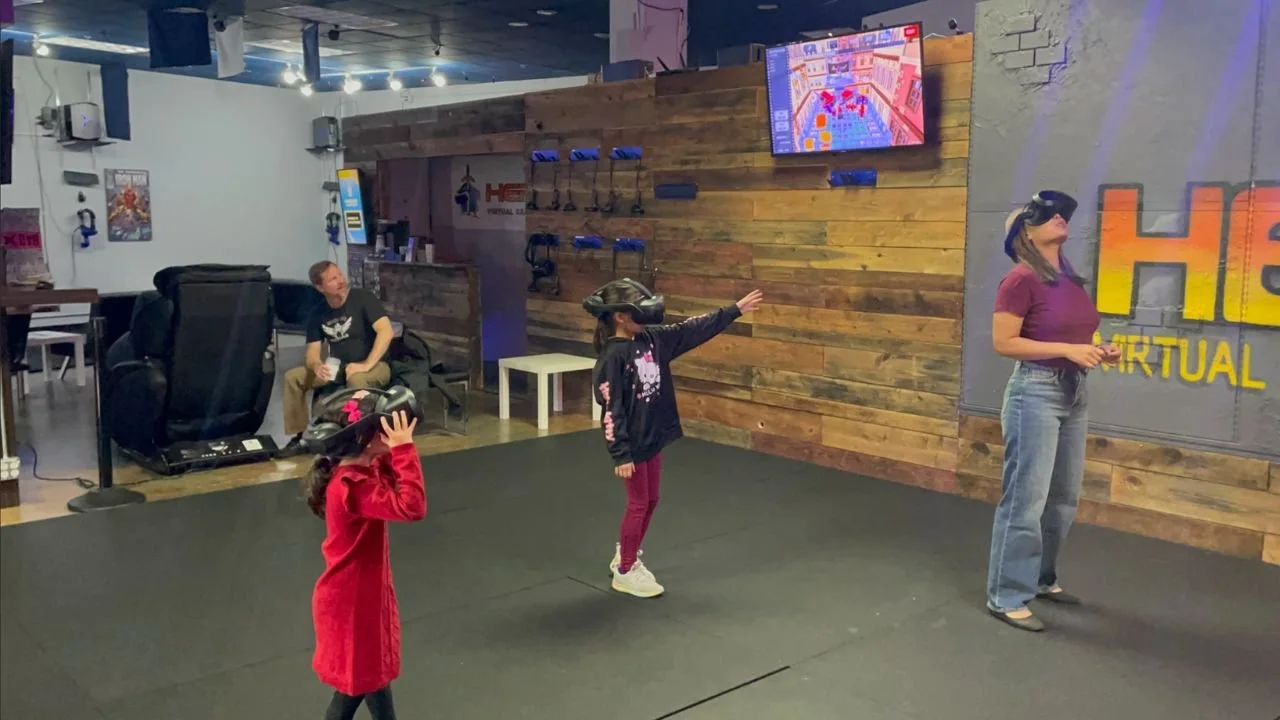 Kids and adults experiencing VR gaming together at HEROES VR Adventure