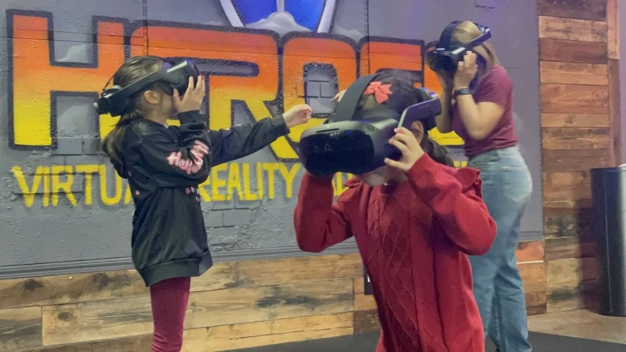 Man playing VR game with headset and controllers