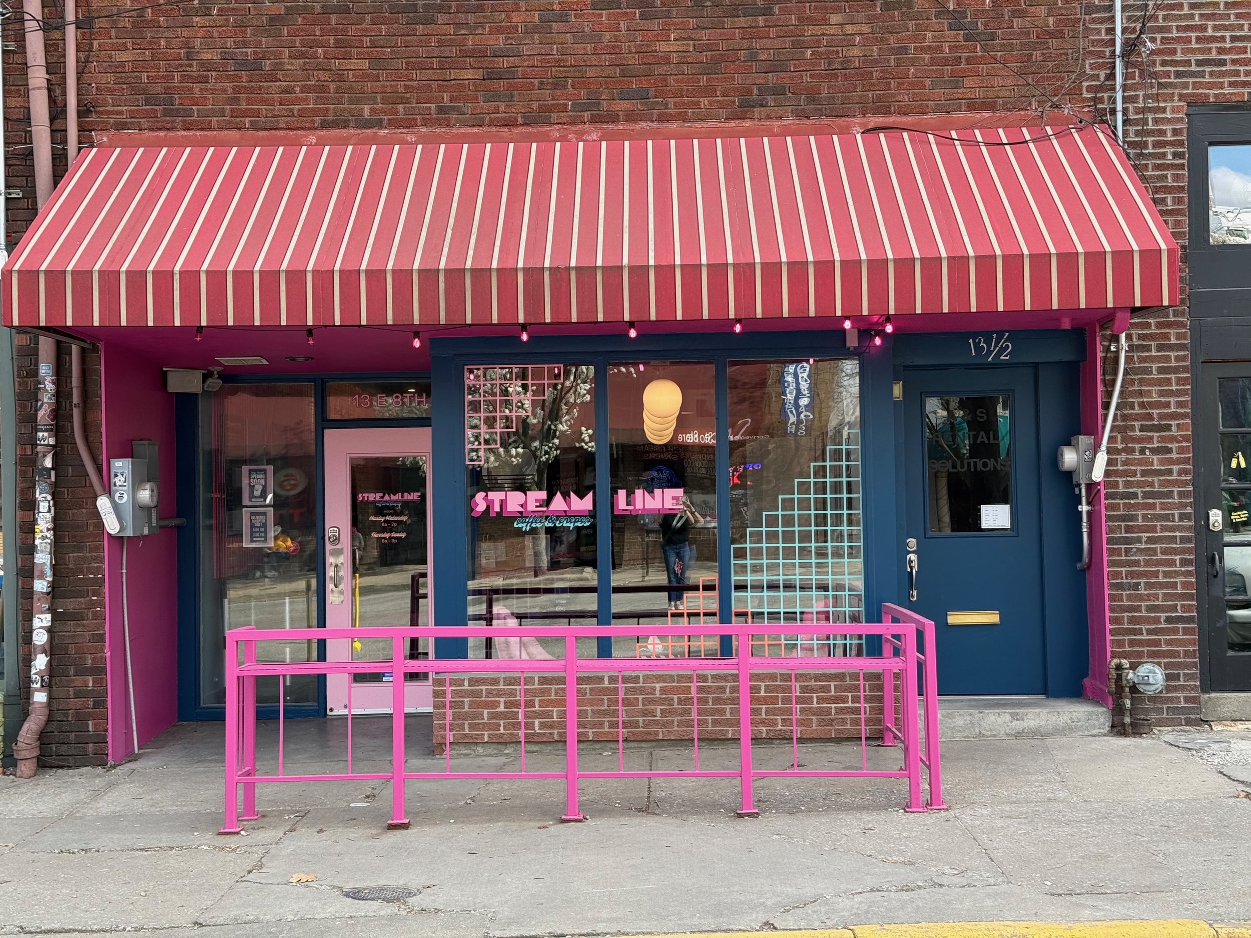 While the lease didn't allow them to change the awning, we were still able to create a striking effect for the building exterior with paint colors and window decals.