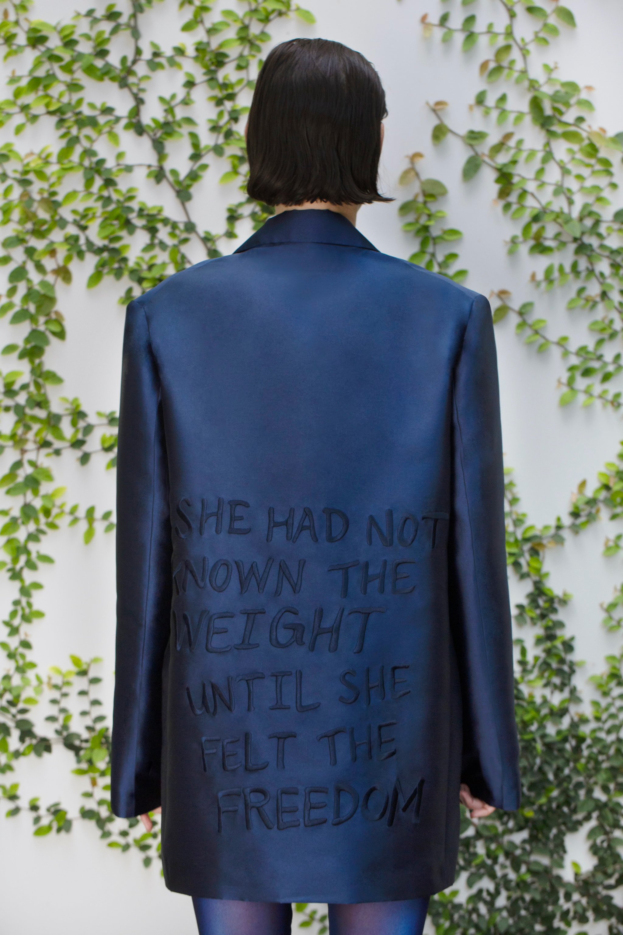 The lookbook image and final application of the Scarlet Letter embroidery on a silk wool blazer.