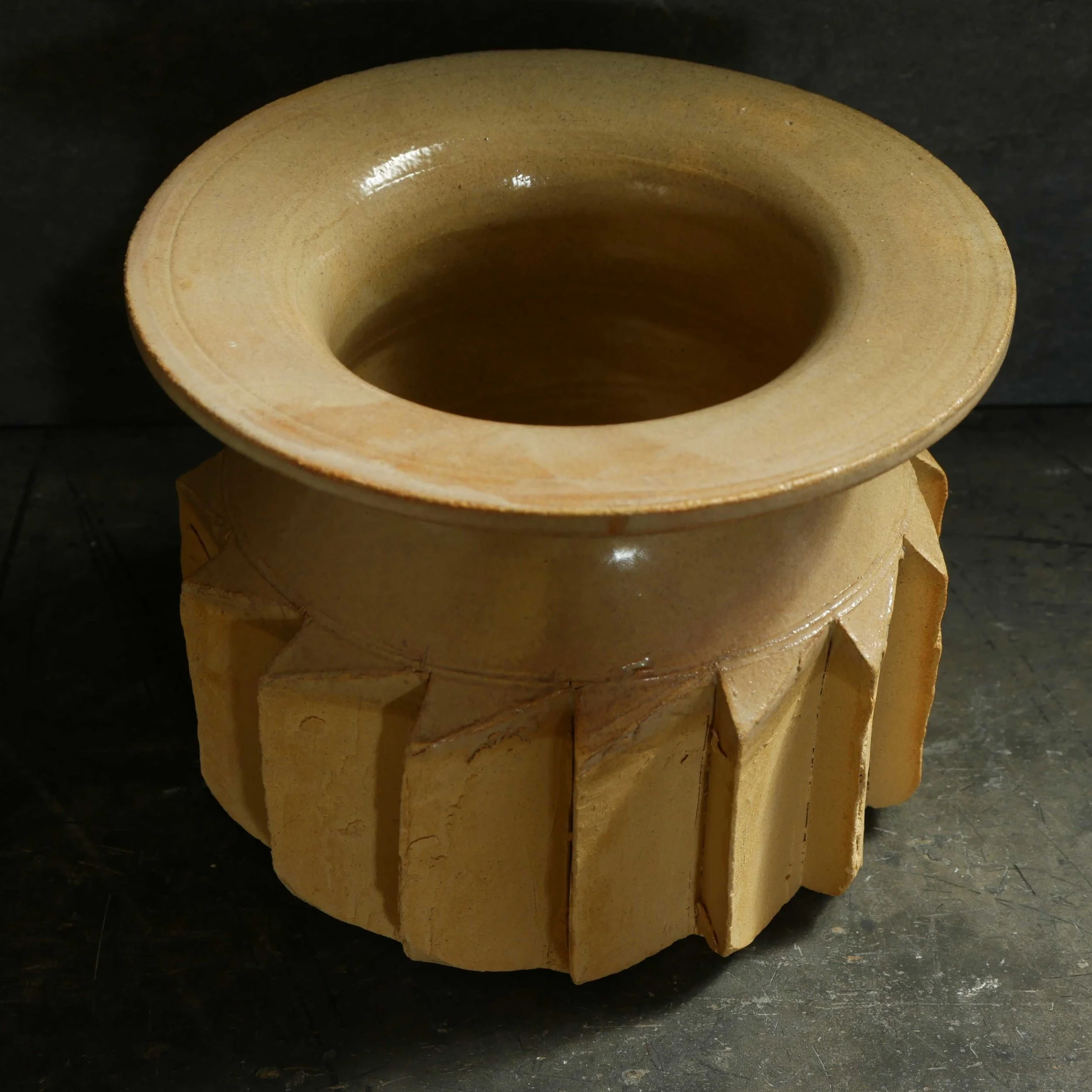 sharp cog feature cut into the wall of a hand thrown pot in golden yellow glaze by Andy van Vliet