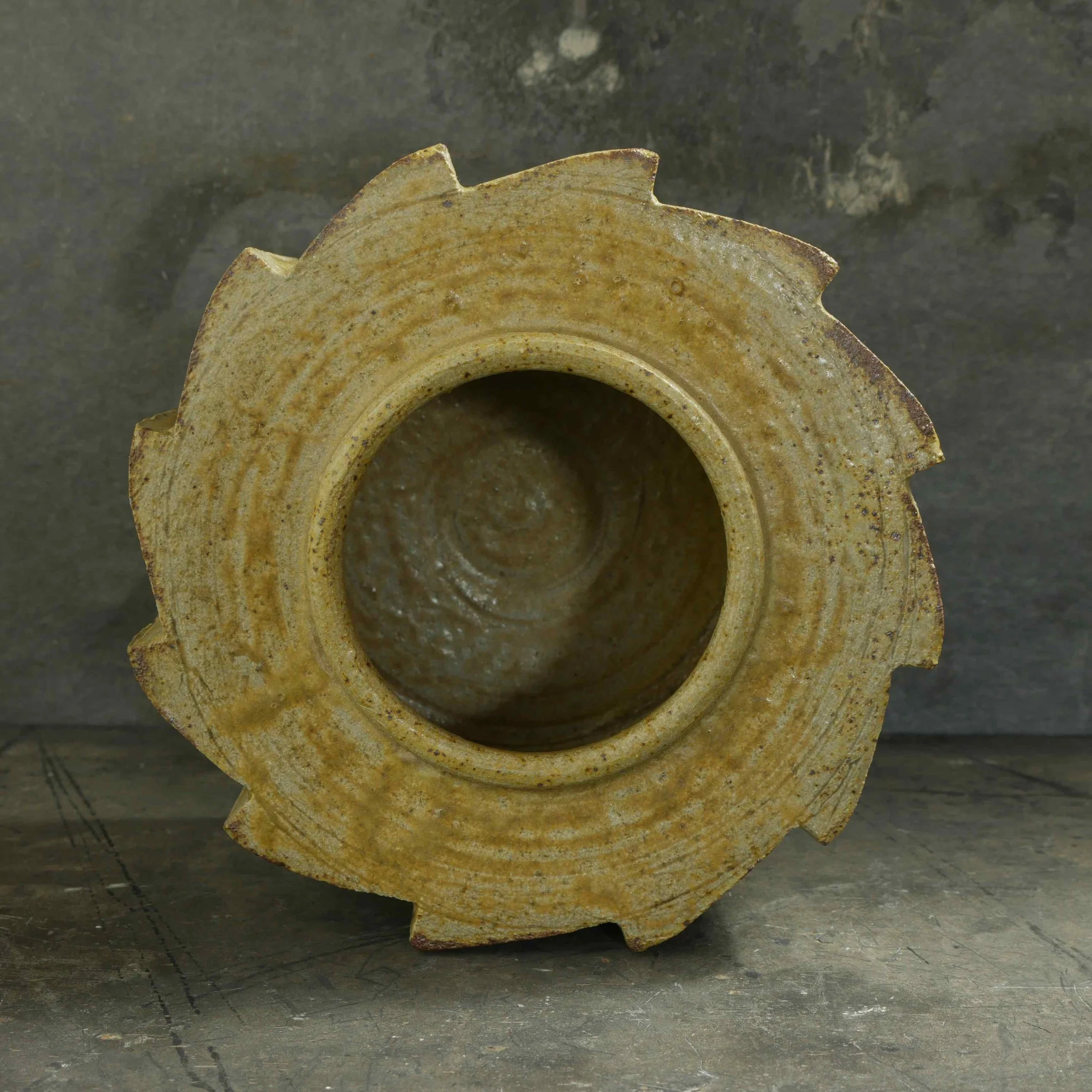 ratchet cog design pot in ash glaze by Andy van Vliet