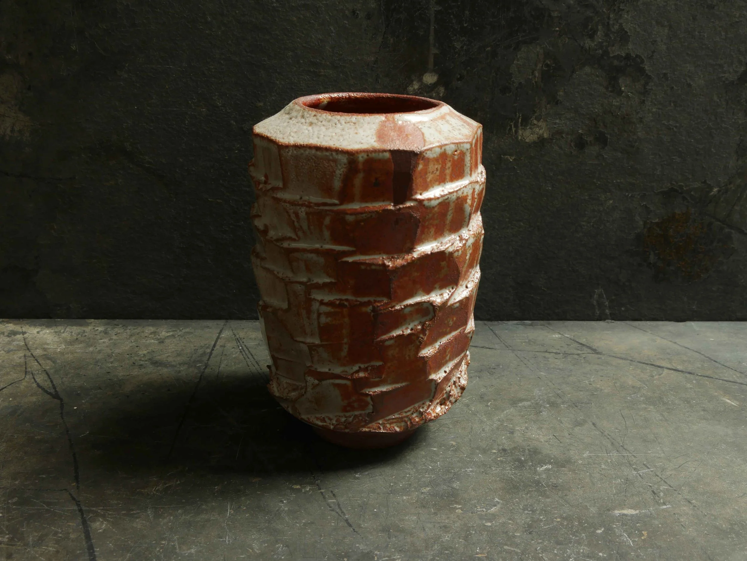 facetted vase in white and orange shino glaze by Andy van Vliet