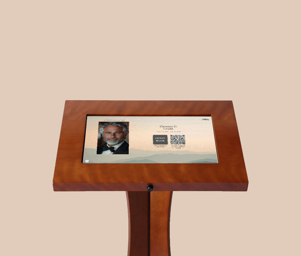 A digital guestbook touchscreen in a wooden kiosk with a photo of an elderly woman, her name, birth and death dates, a QR code, and options for signing in on a device.