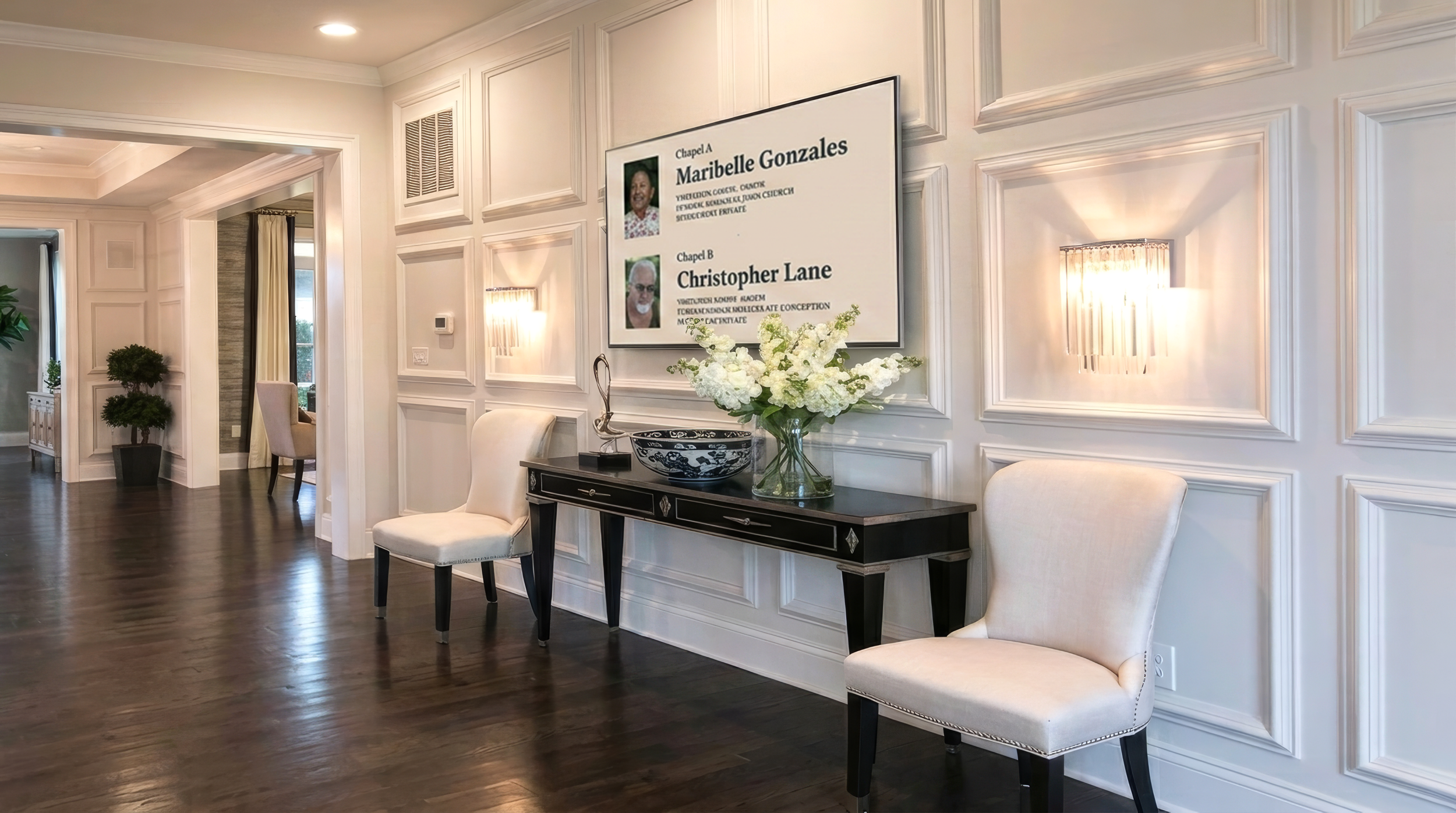Funeral home guests reading service and chapel information on The Digital Directory in a funeral home entrance