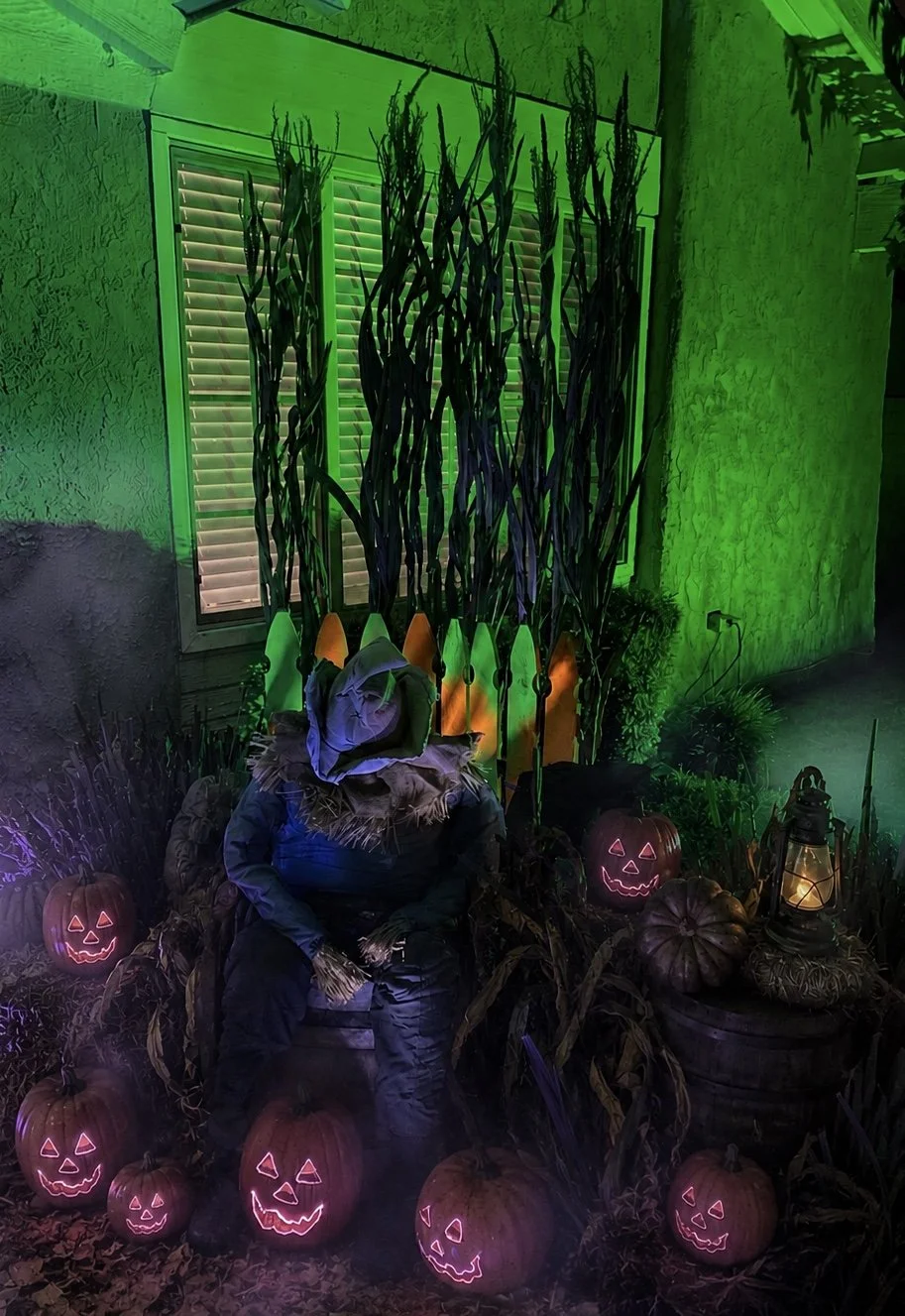 Halloween scarecrow display with glowing jack-o-lanterns, Los Angeles