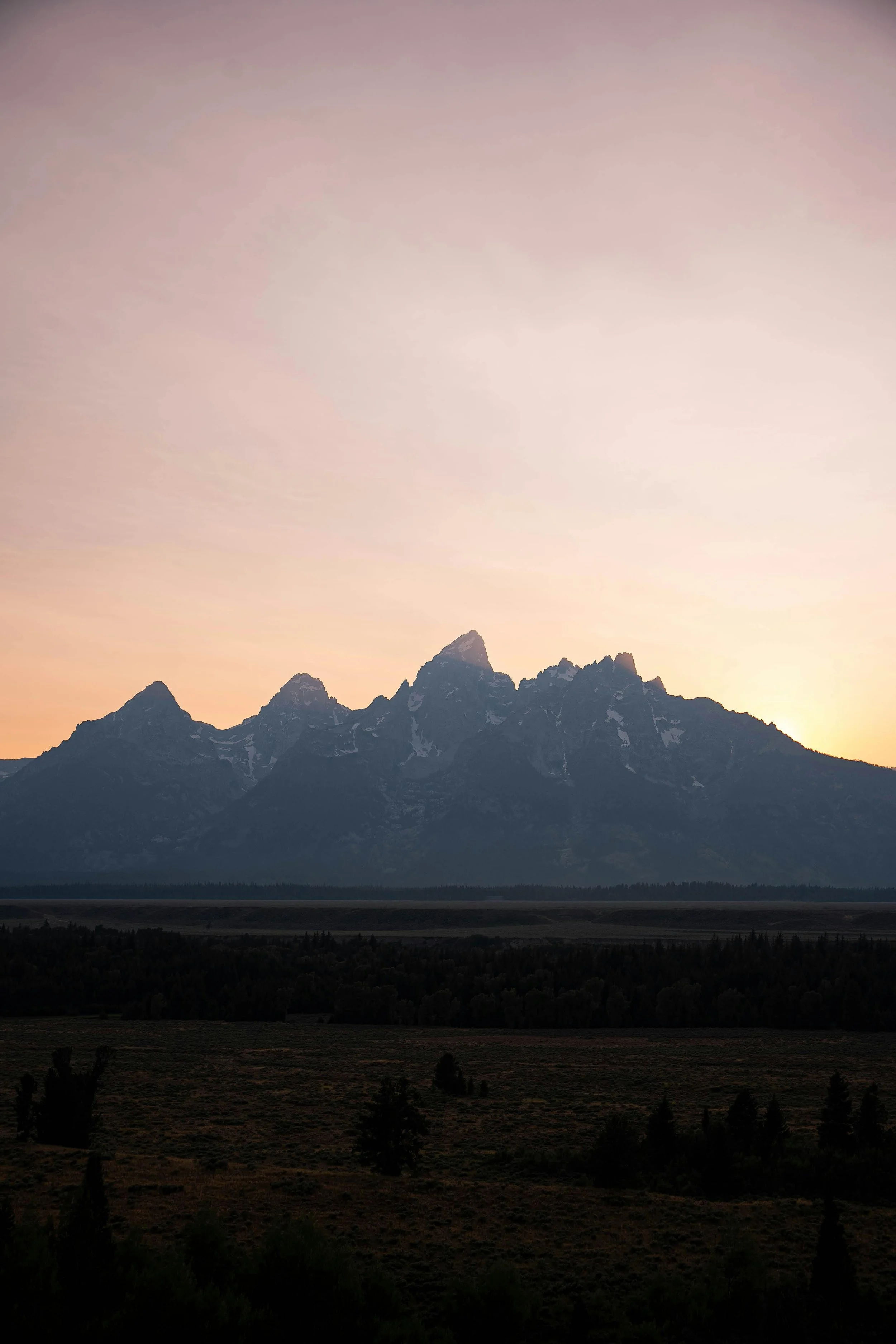 A subtle sunset behind the Grand Tetons