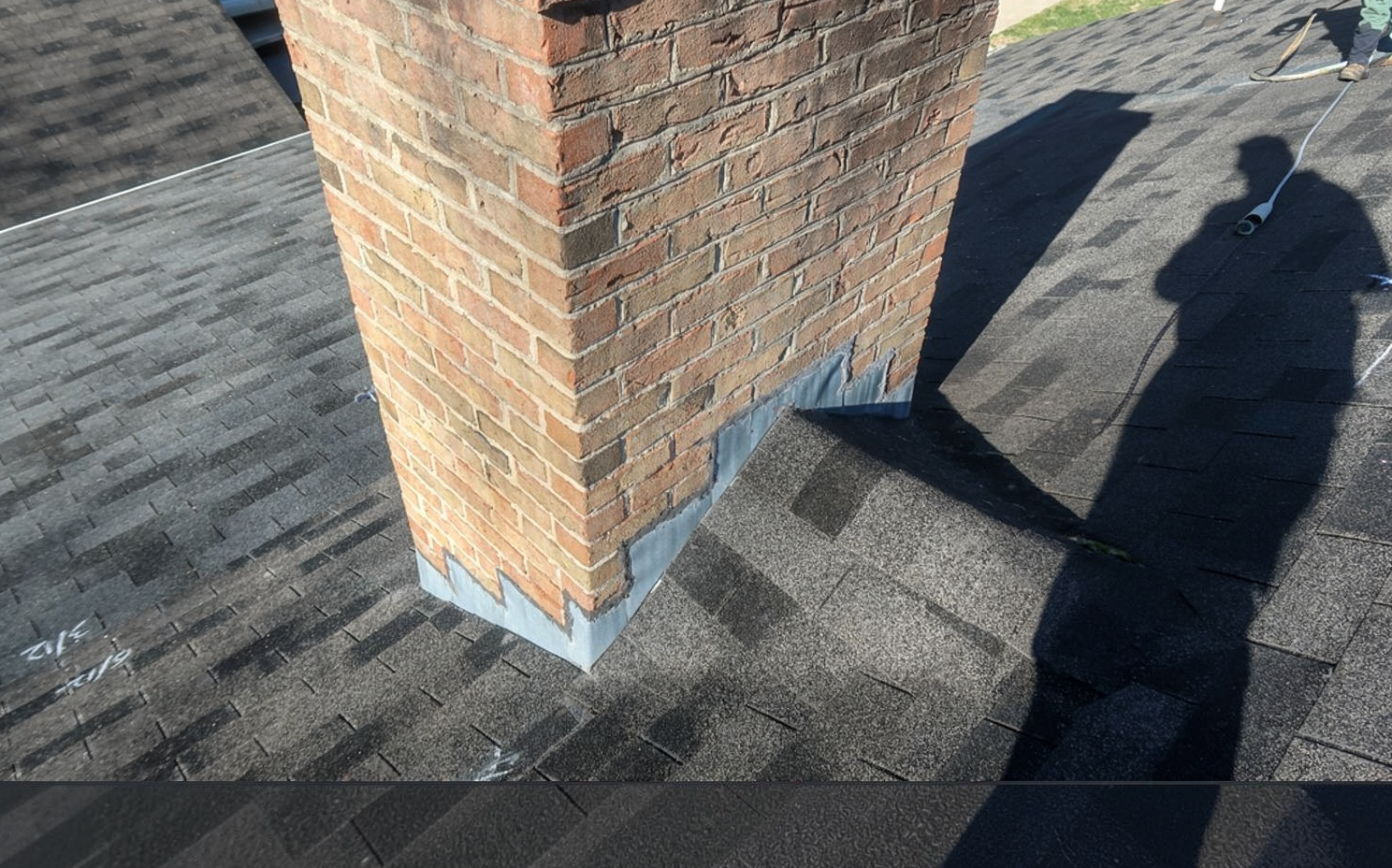 Durable residential roofing system with brick chimney designed for long-term performance in tropical climates