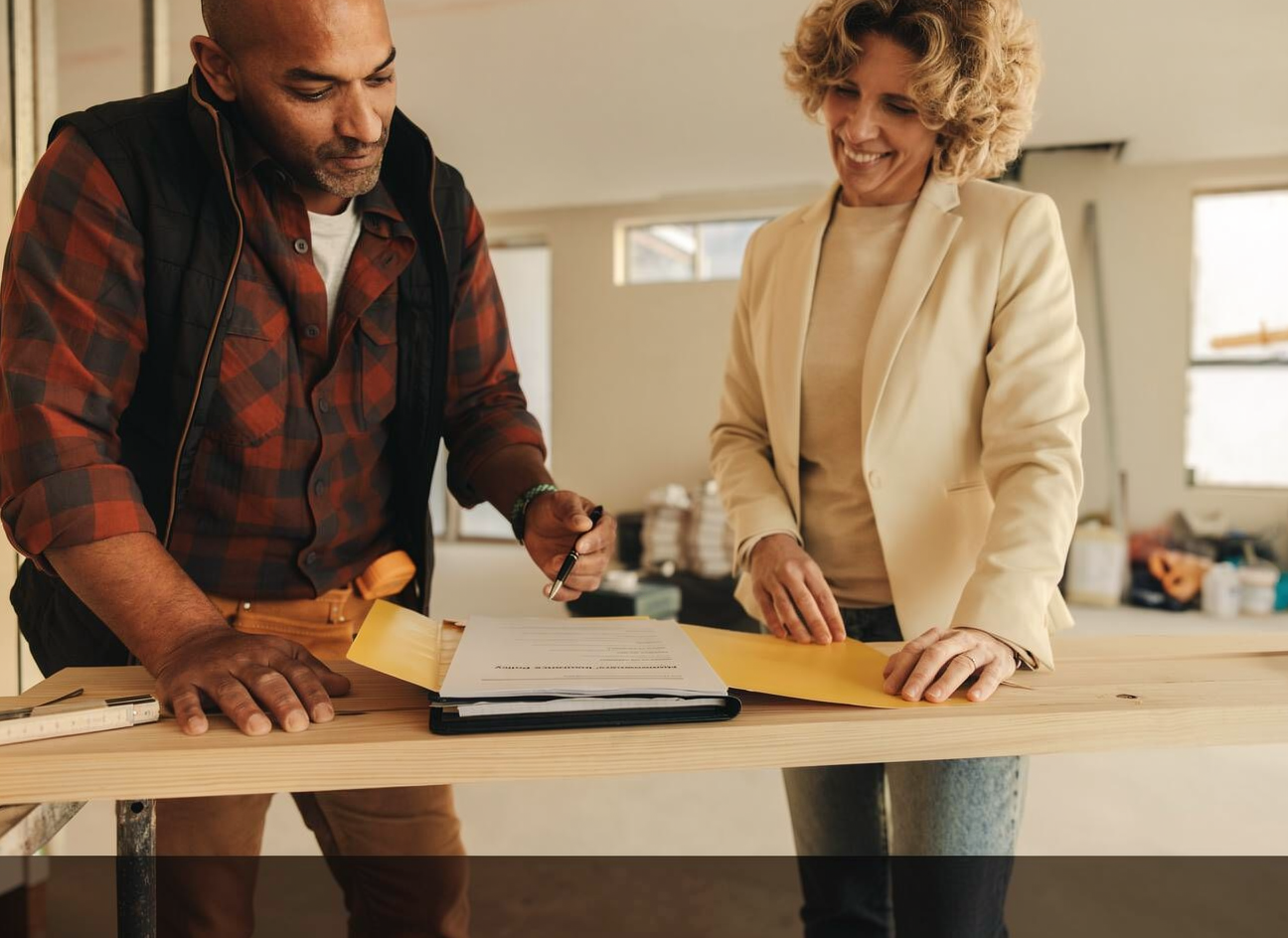 Homeowners reviewing insurance claim paperwork with expert construction and claims guidance