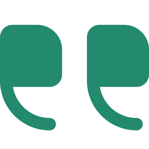 Close-up of two green quotation marks against a black background.