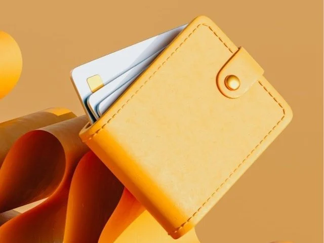 A bright colored wallet with credit cards