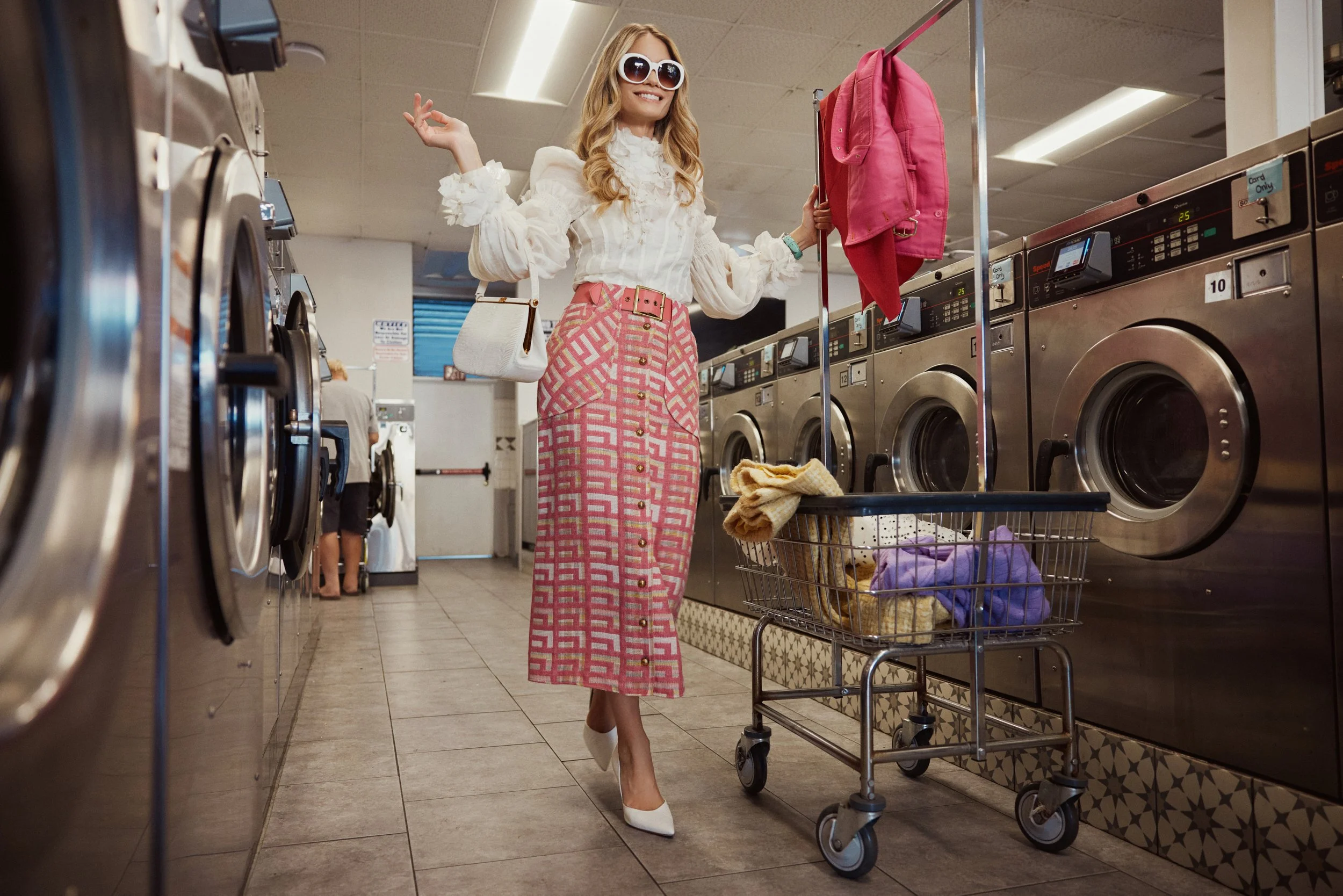 Woman in a tweed skirt with a shopping cart in a laundromat, fashion editorial | Jon Premosch, fashion and lifestyle photographer