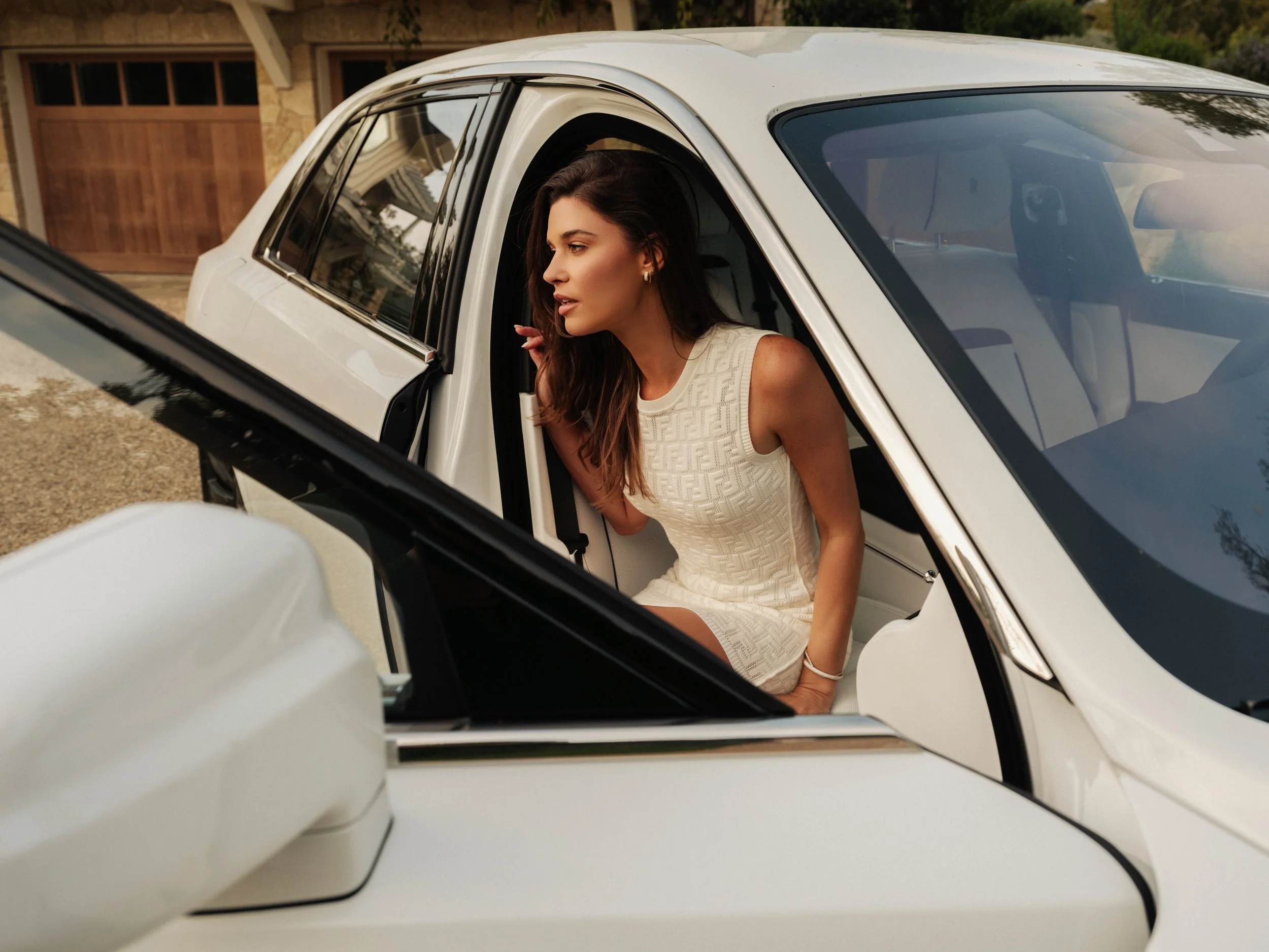 Woman leaning out of a white car door, automotive lifestyle photography | Jon Premosch, fashion and lifestyle photographer