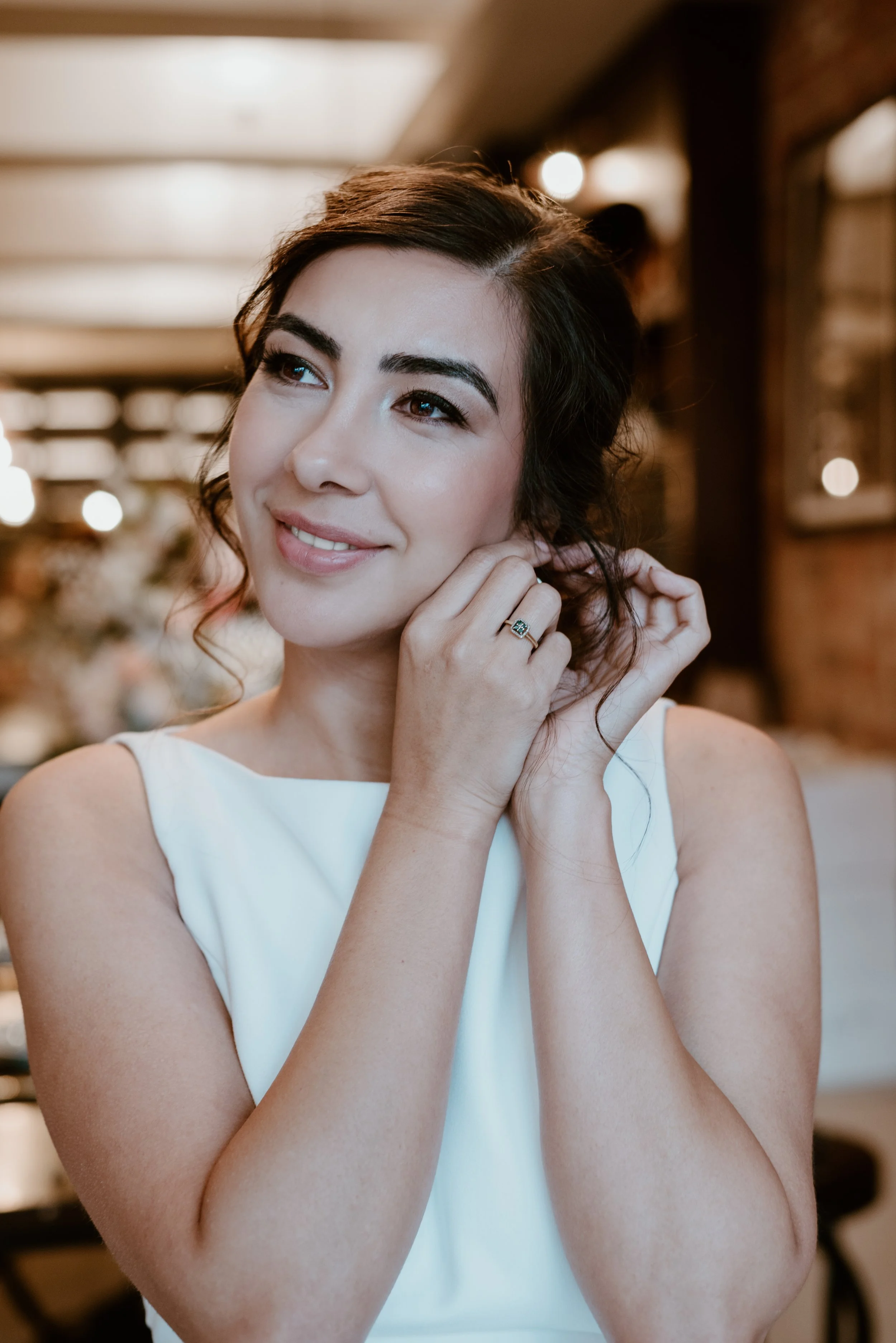 Classy bride with enhanced beauty makeup and hair at a romantic downtown wine lounge
