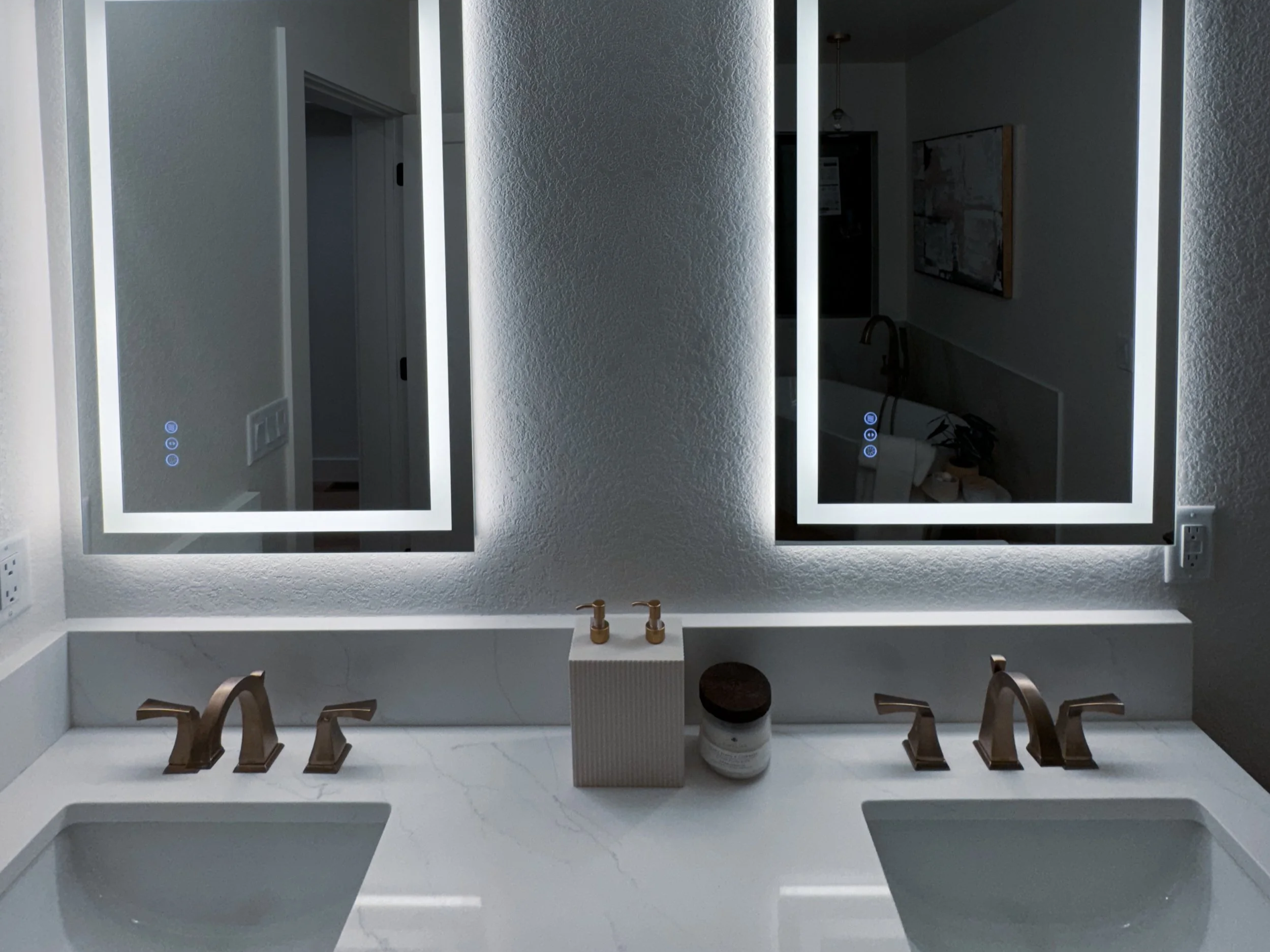 Bathroom remodel with backlit mirrors. Built by Stellaris Build Co.