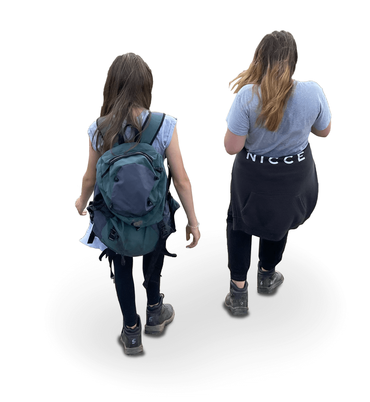 Two women walking away, one with a backpack, wearing sunglasses, and a casual outfit, the other with a sweatshirt that says 'NICE' around her waist, casual clothing and sneakers.