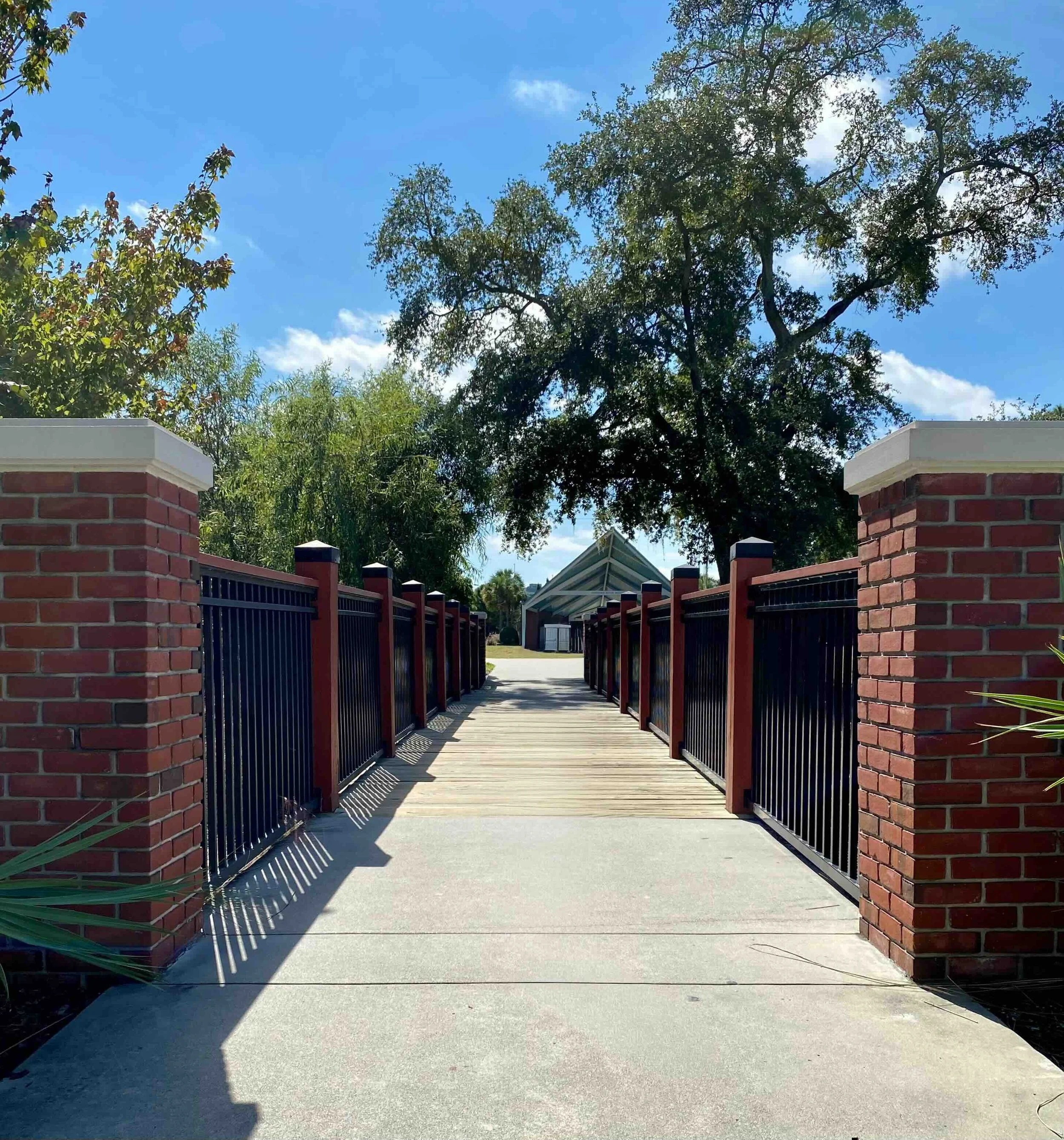 wooden pedestrian bridge, walkway, with brick railing